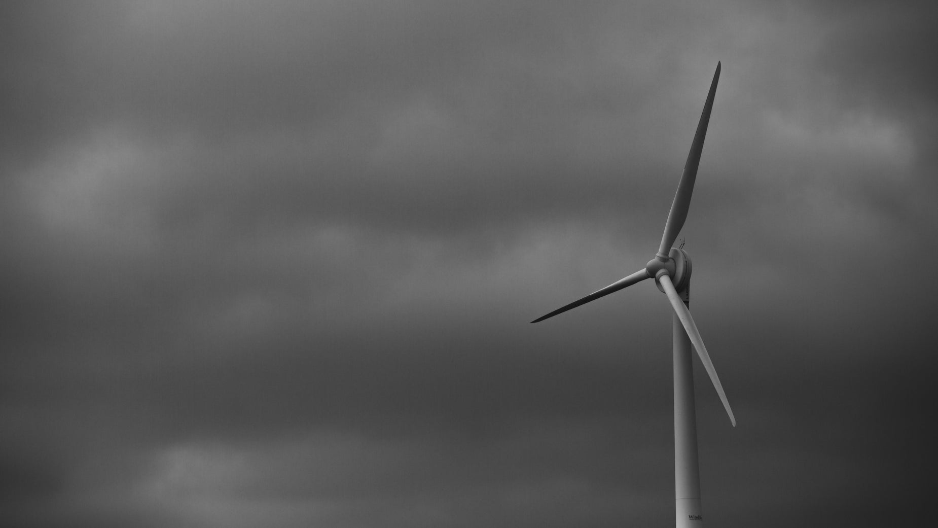 wind turbine on cloudy day in a field