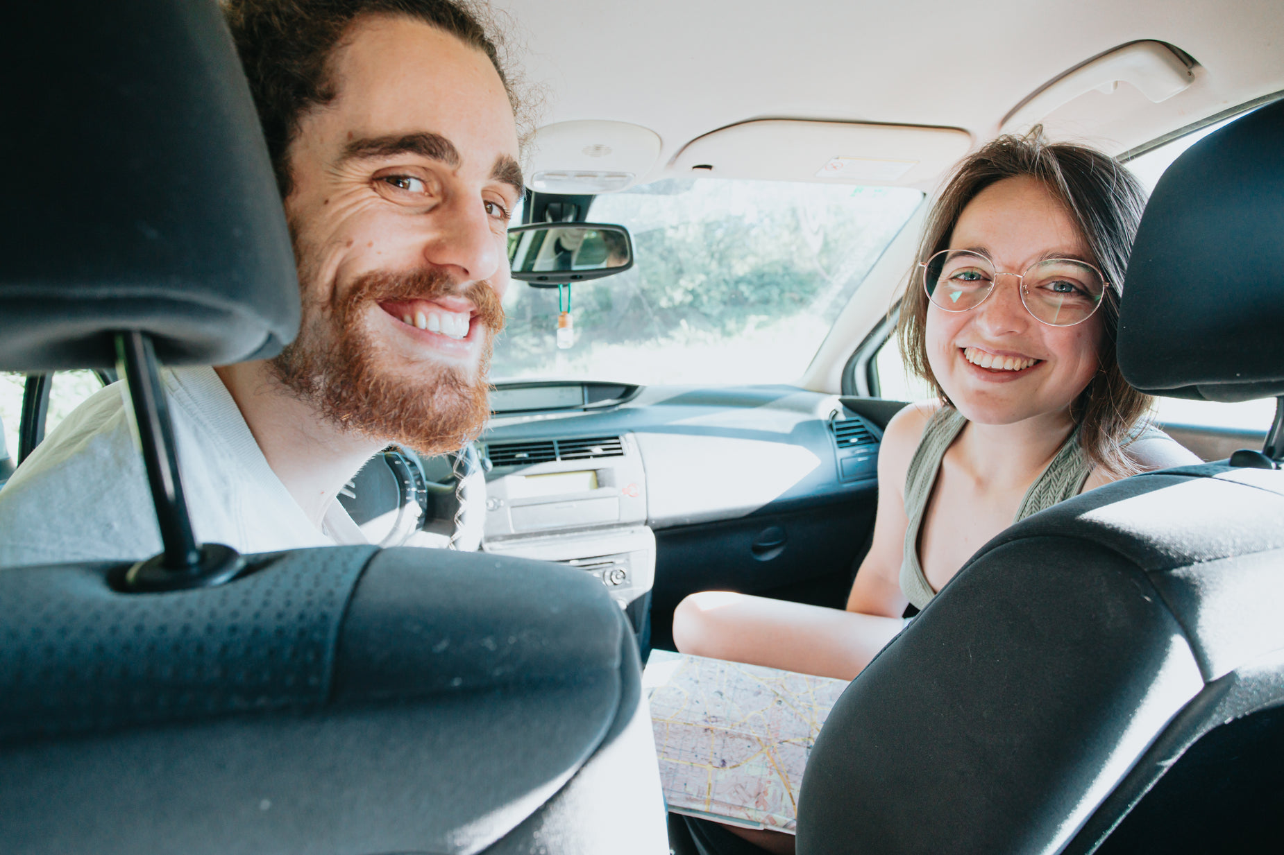 a happy couple in the backseat of a car