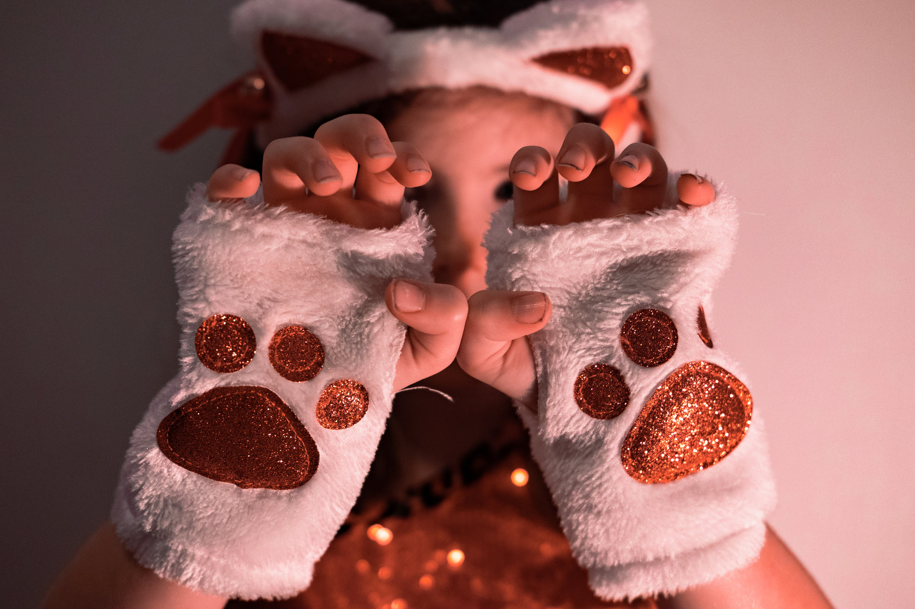 a young person in a furry outfit and matching white gloves