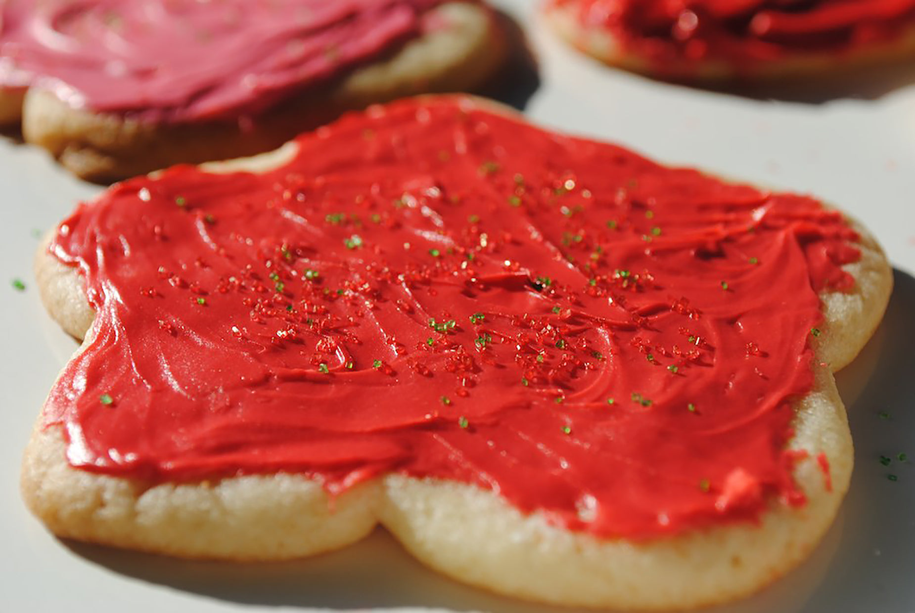 cookie pieces with red icing and sprinkles