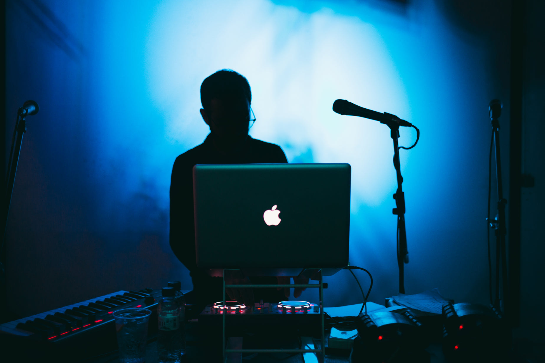 a man playing an apple computer in a darkened room