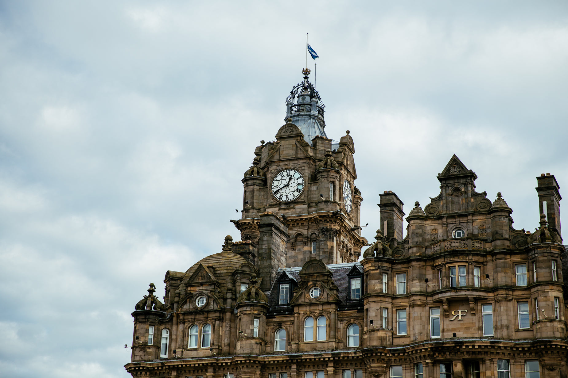 a large brown building with a clock on top