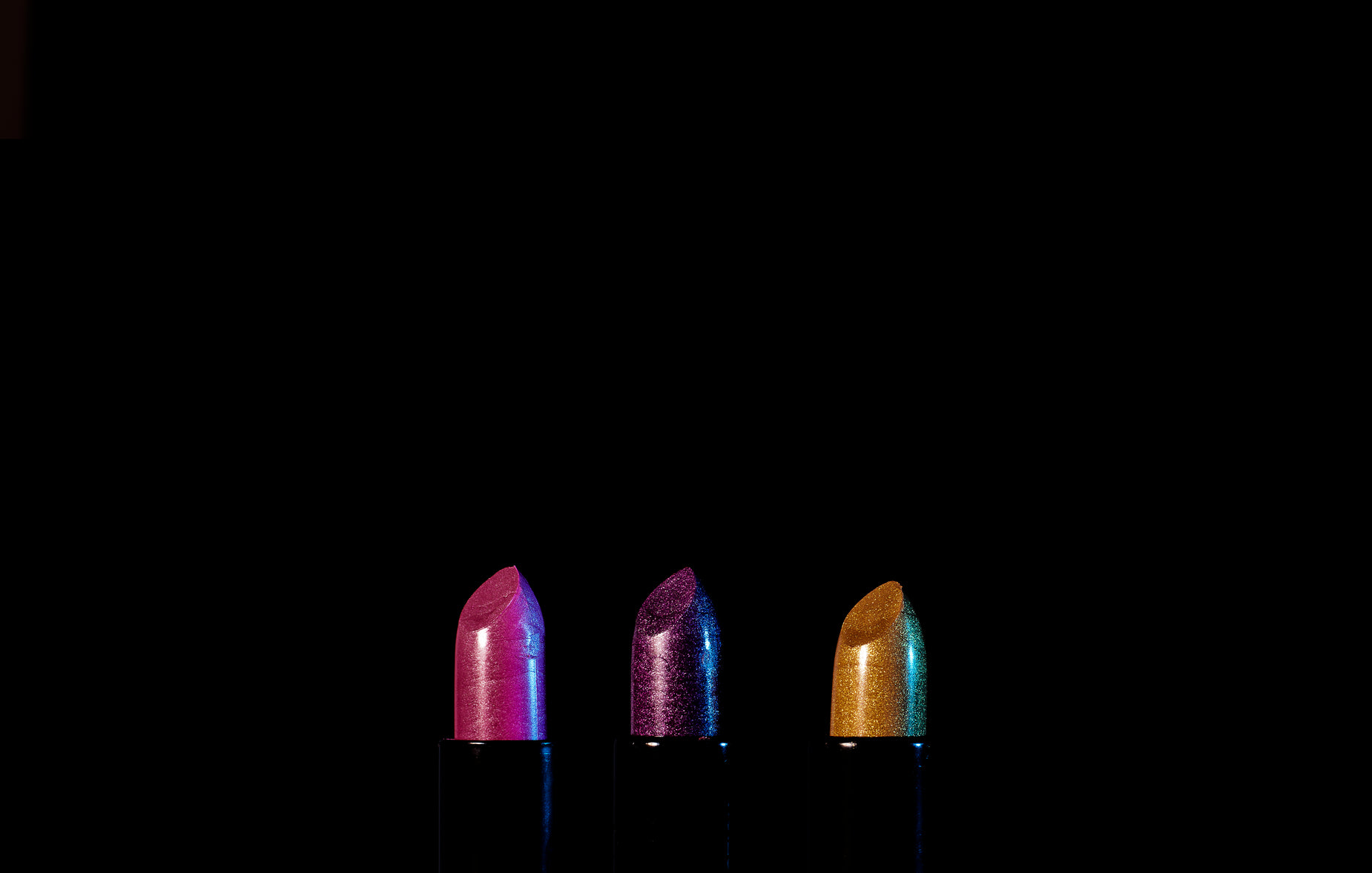 there is a row of small colored lipsticks lined up in a row