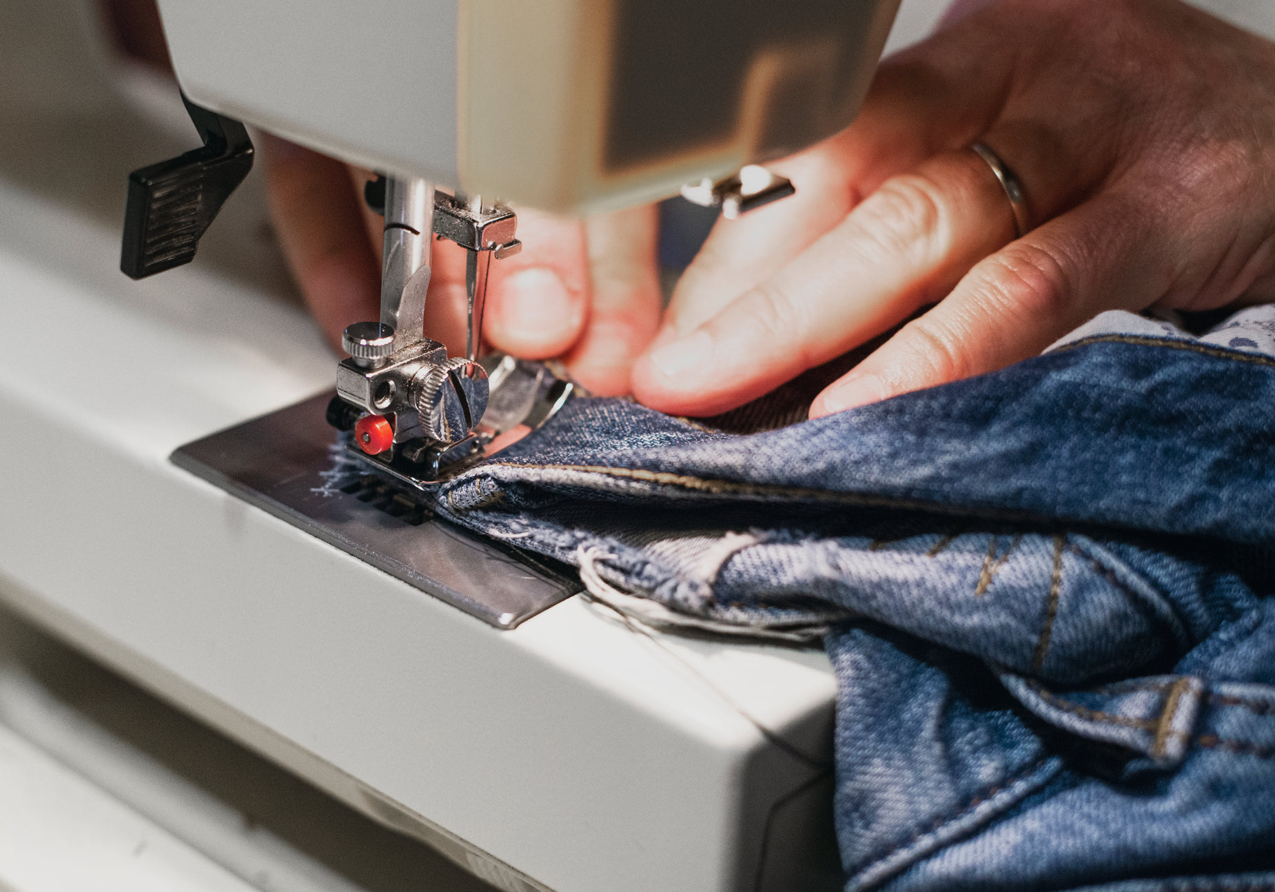 a person is using a sewing machine to sew clothes