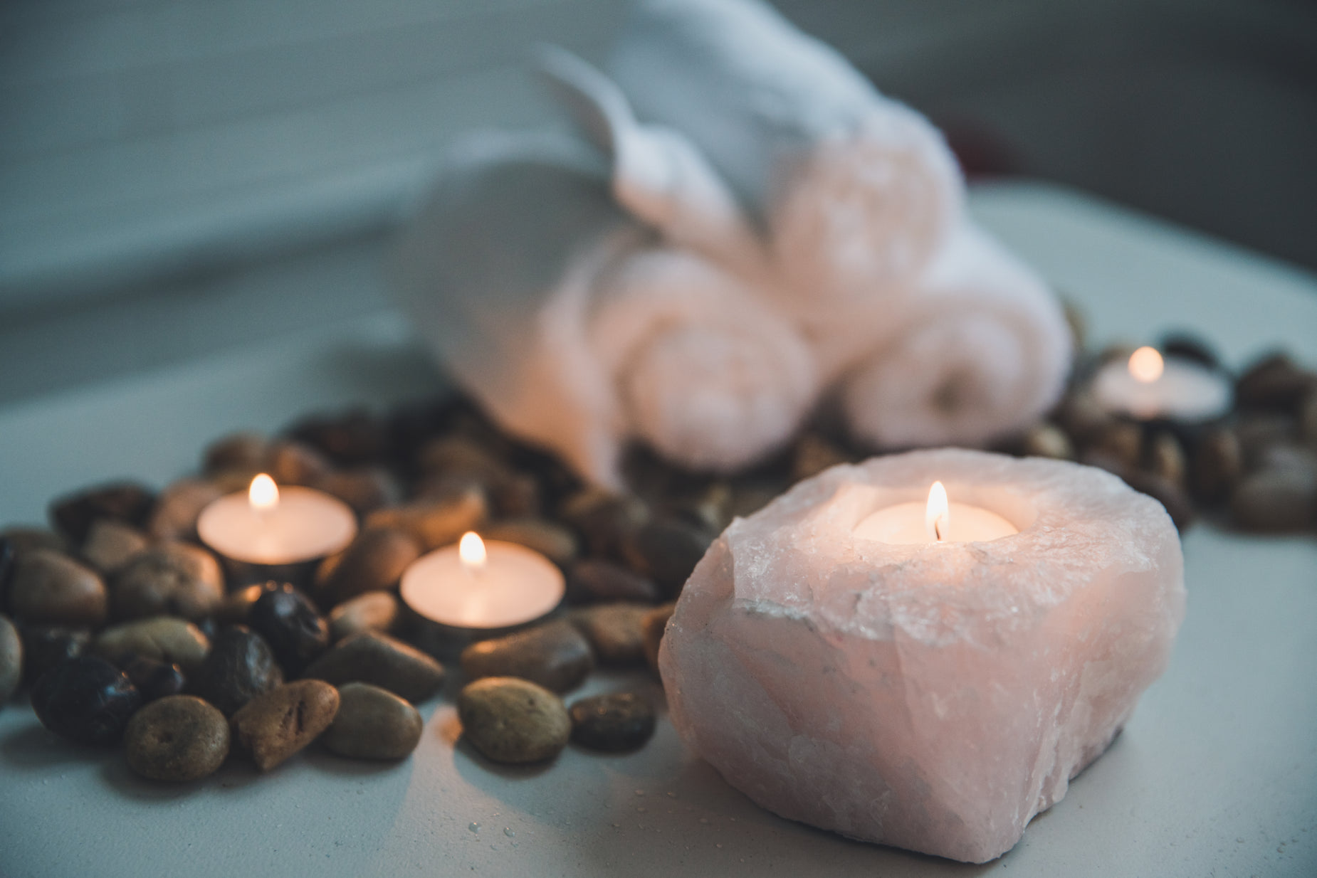 a candle sitting next to several rocks and candles
