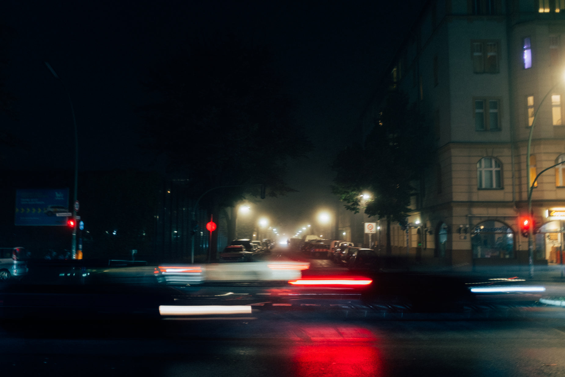 several traffic lights on the corner of a busy street