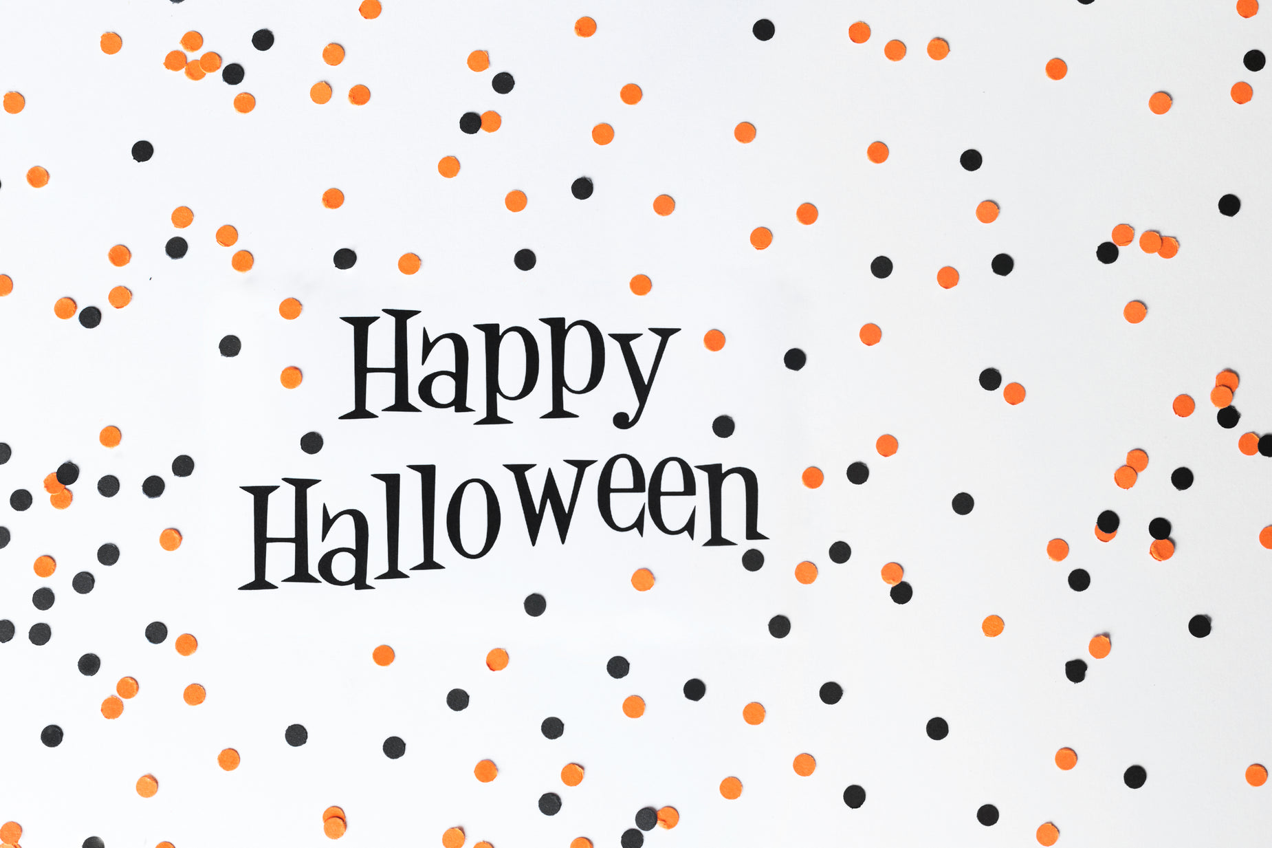 happy halloween with orange black and white dots and a sprinkled text design