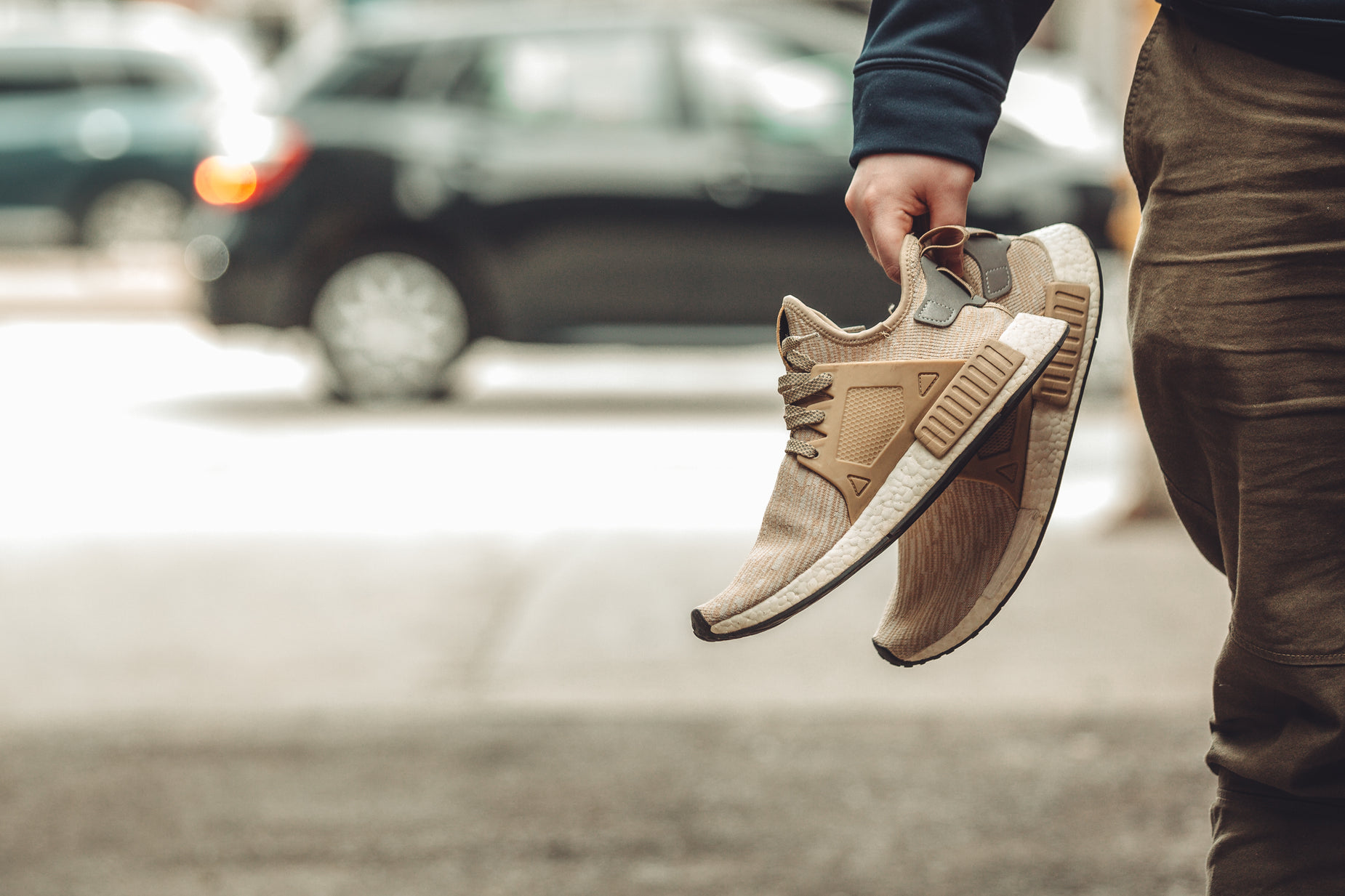 a man with brown shoes is walking down the street