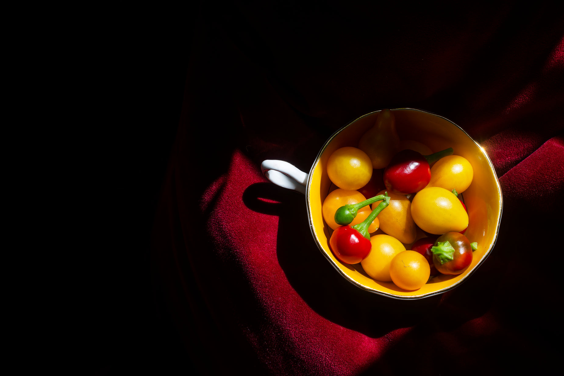 a bowl filled with some yellow and red fruit