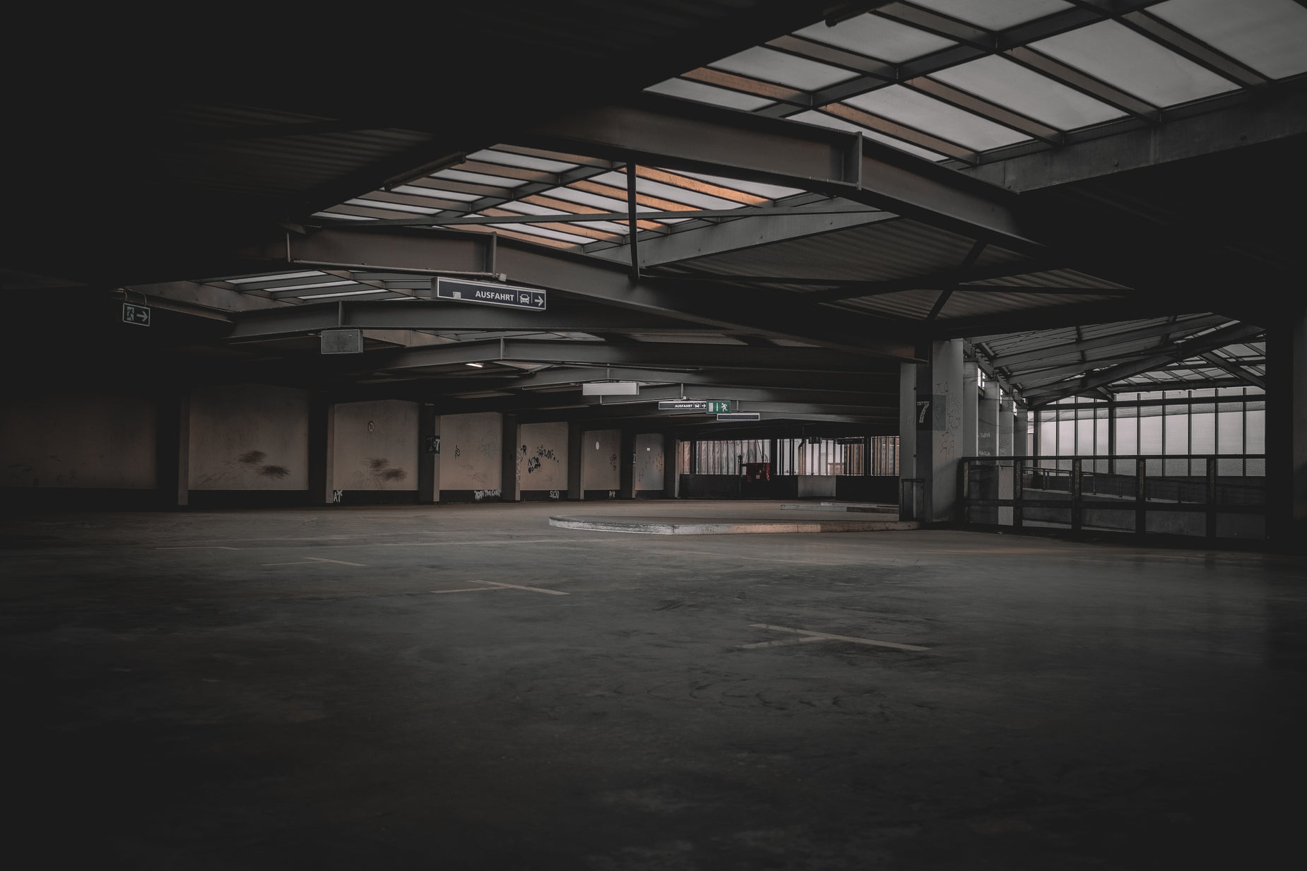 a empty warehouse building has a broken door and a large glass window