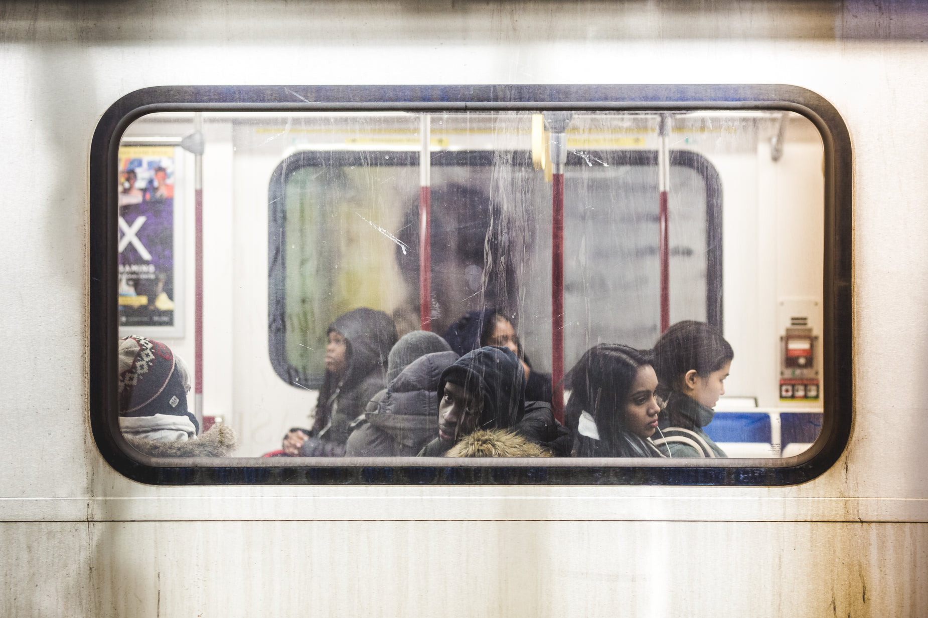 a group of people sit on a subway train