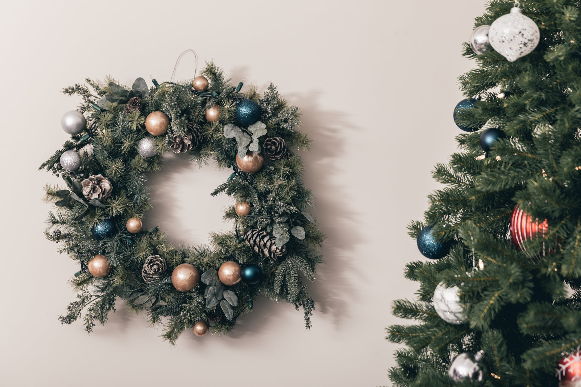 an artificial wreath is hung on a wall next to christmas decorations