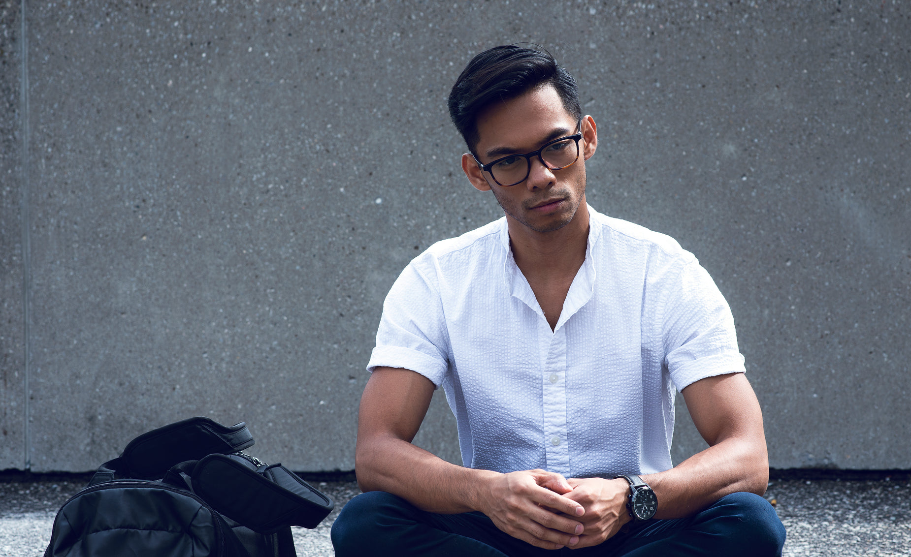 a man in white shirt sitting on the ground