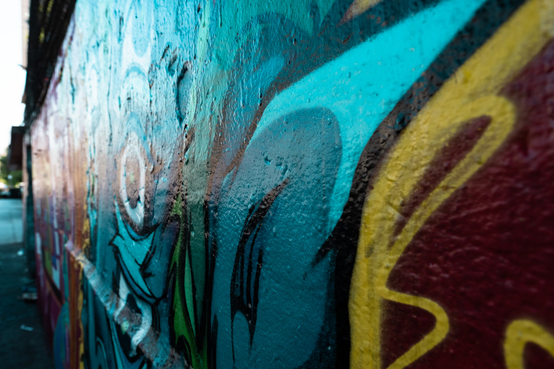 a wall with some very colorful graffiti painted on it