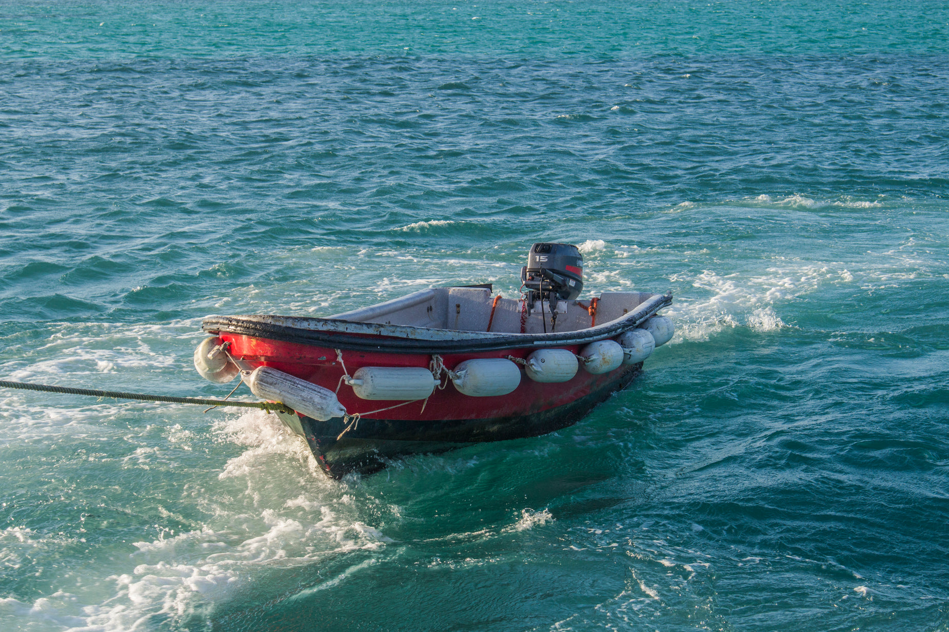 a man riding in an inflatable boat on water