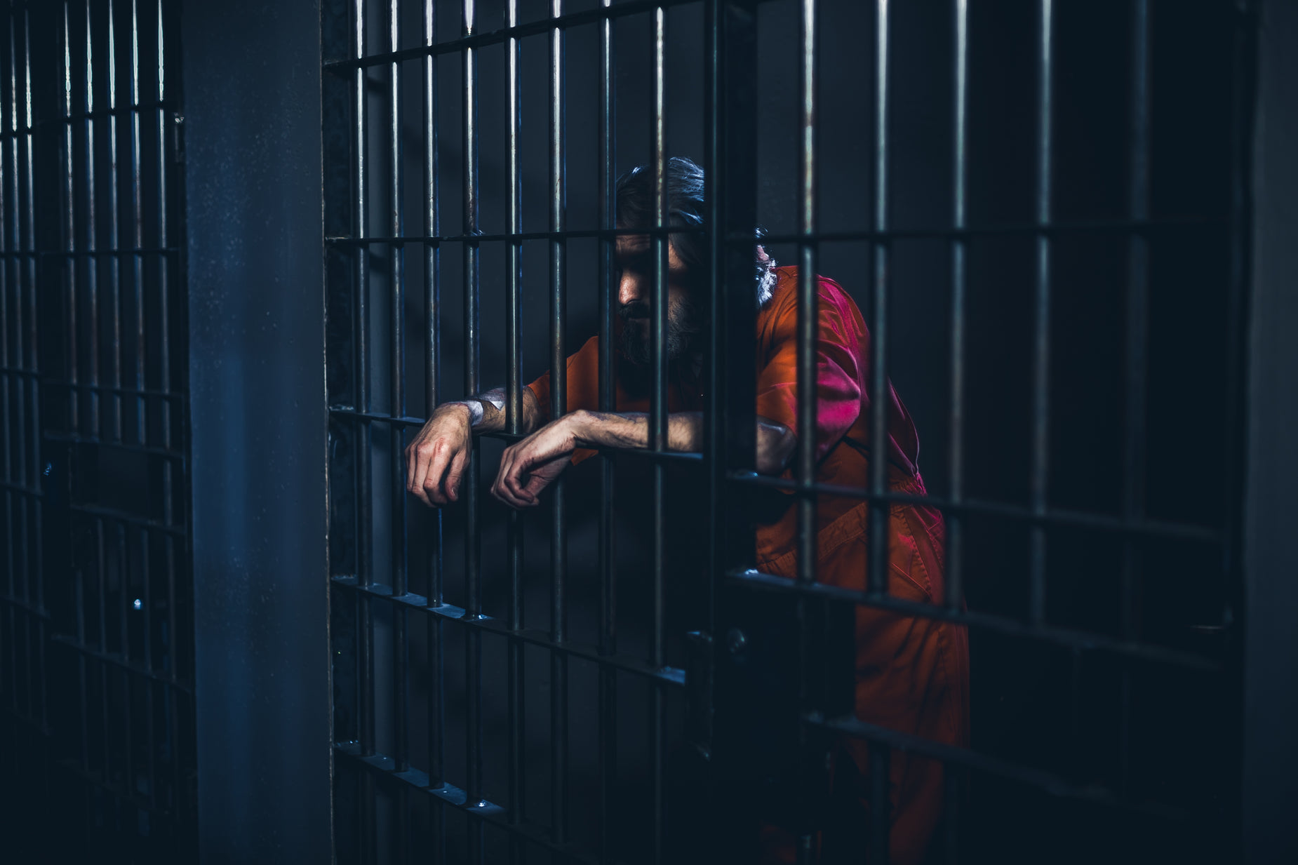 an indian man leaning his head out of  bars