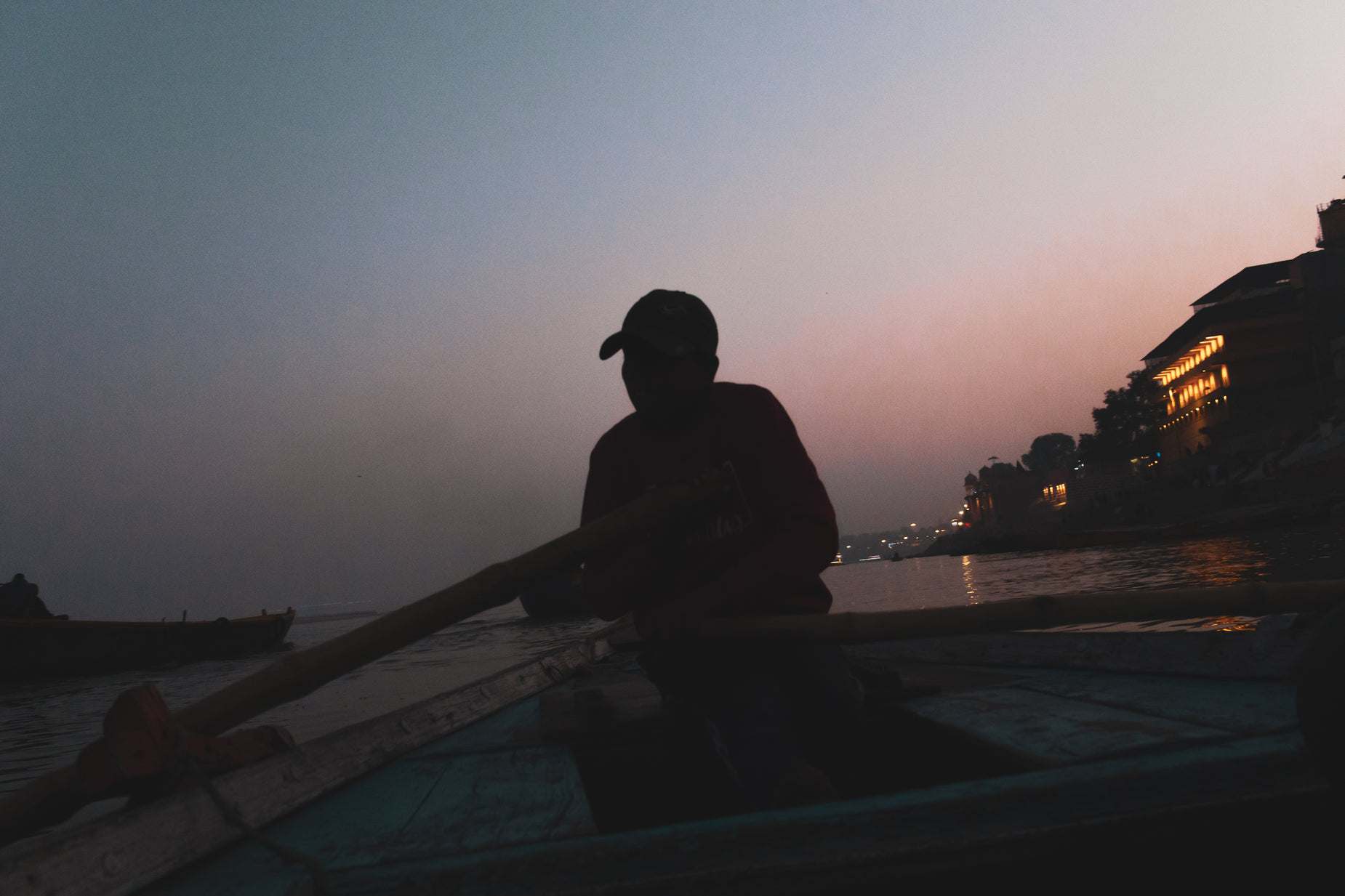 a man with a baseball hat is sitting in a boat