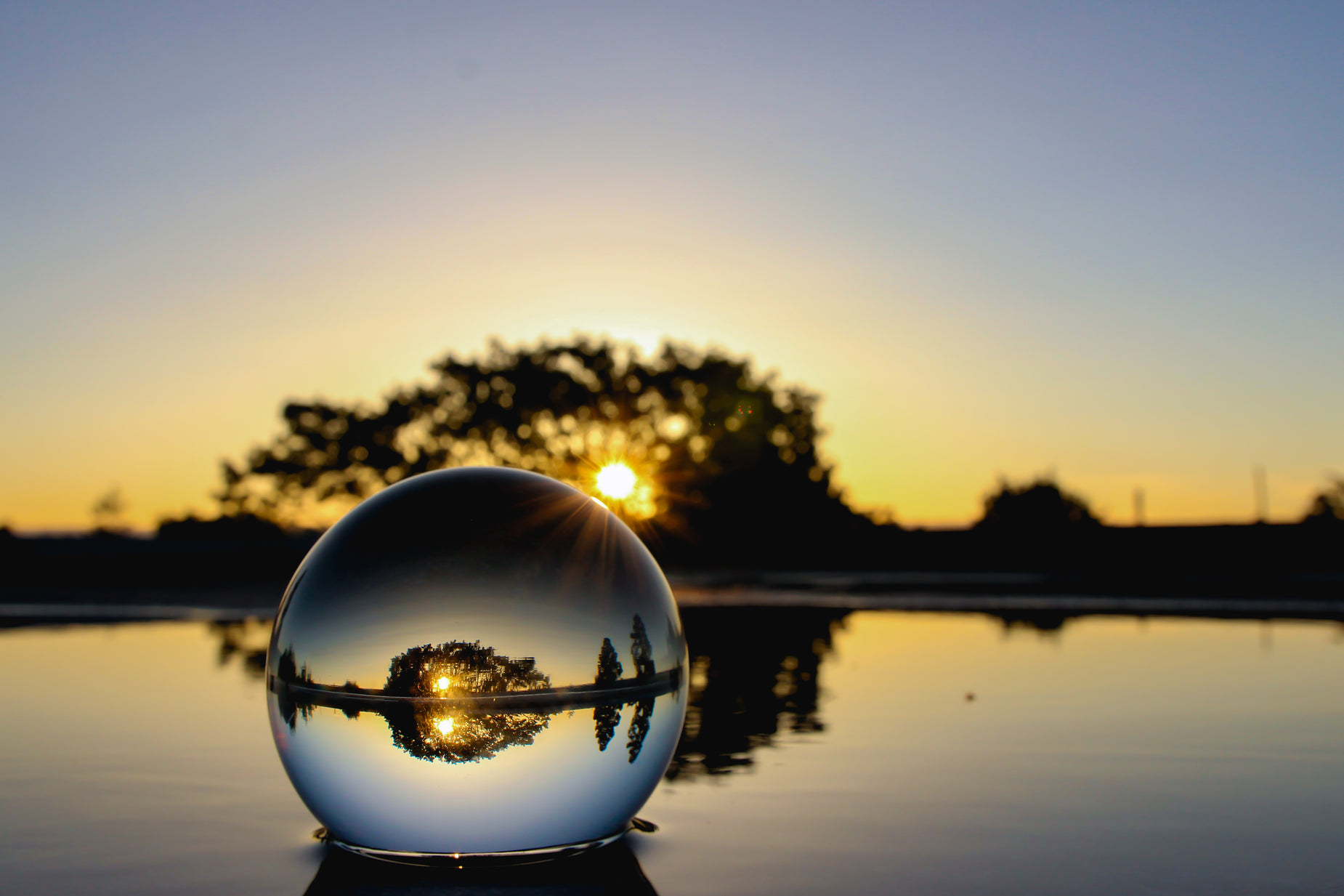 a crystal ball sitting in front of the sunset