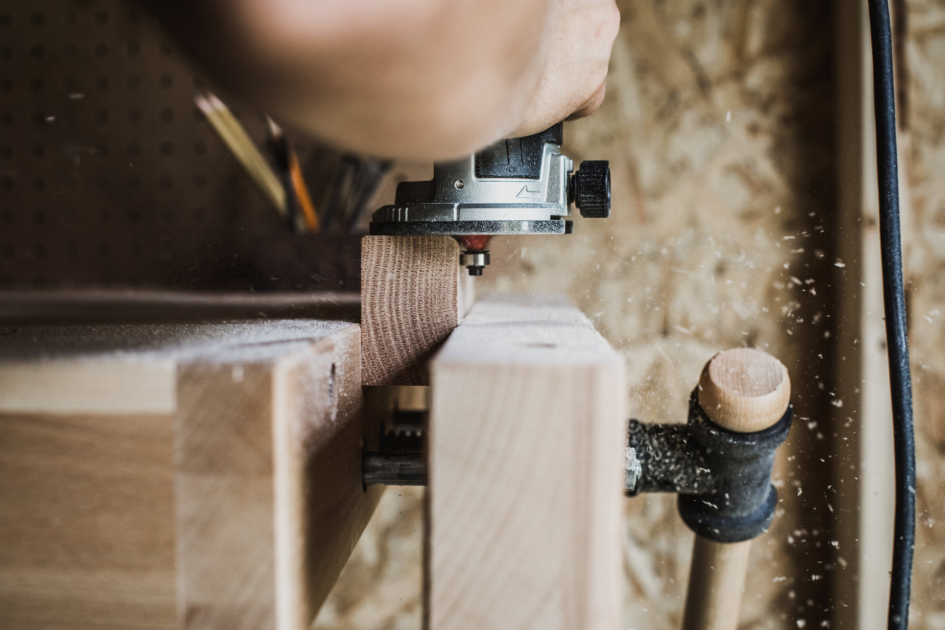 a person making soing on top of a wooden plank