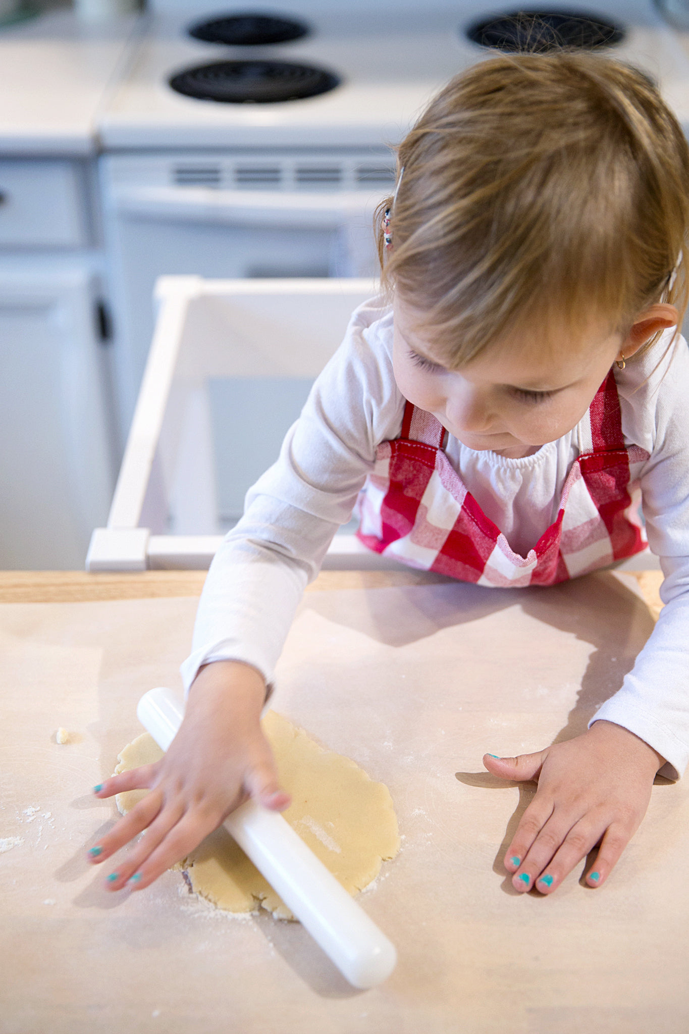 a  using a rolling dough on top of a table