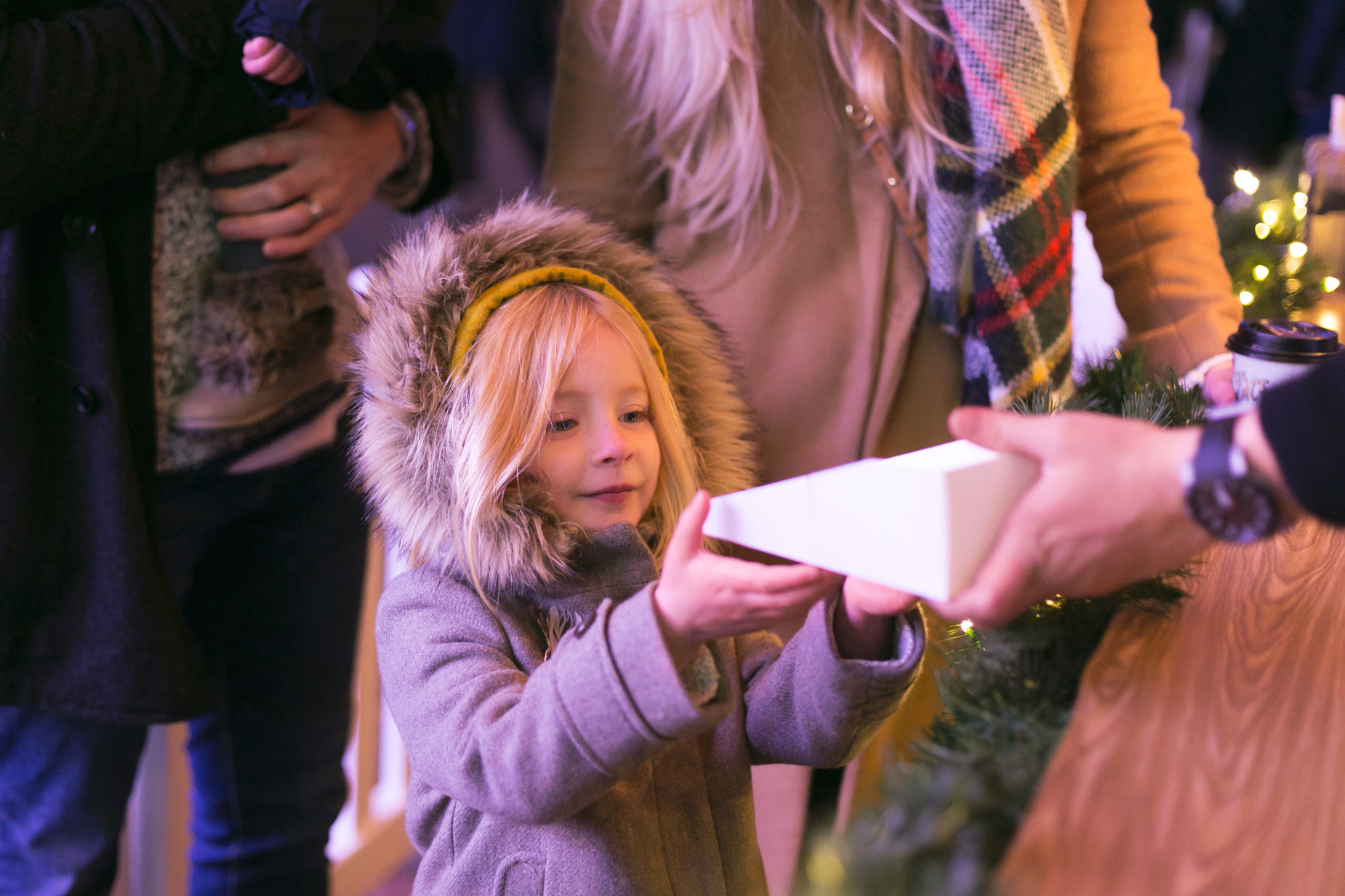 the little girl is trying to get her present