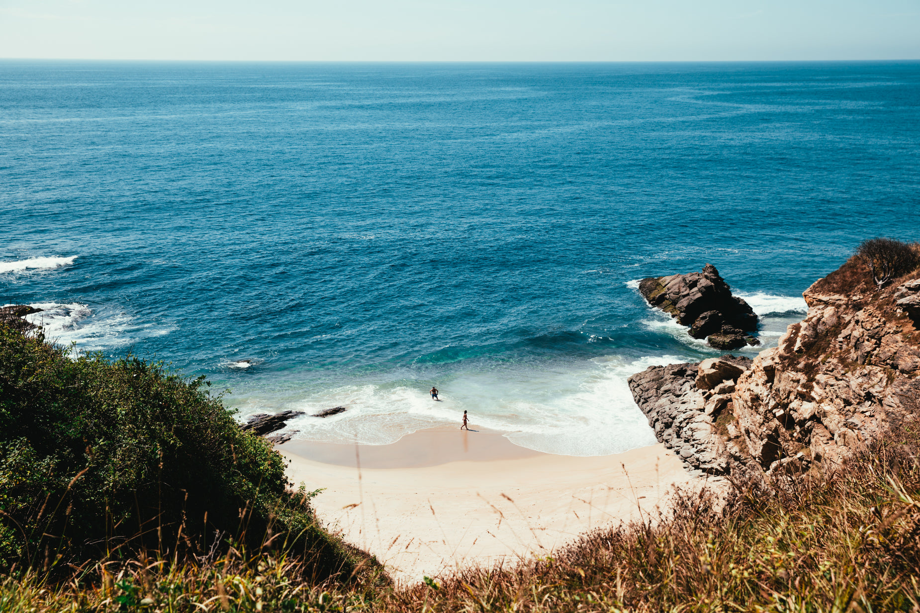 a view looking down on the beach from above