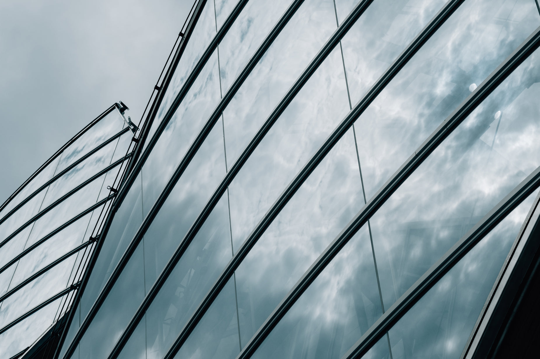 an image of the reflection of the sky behind windows