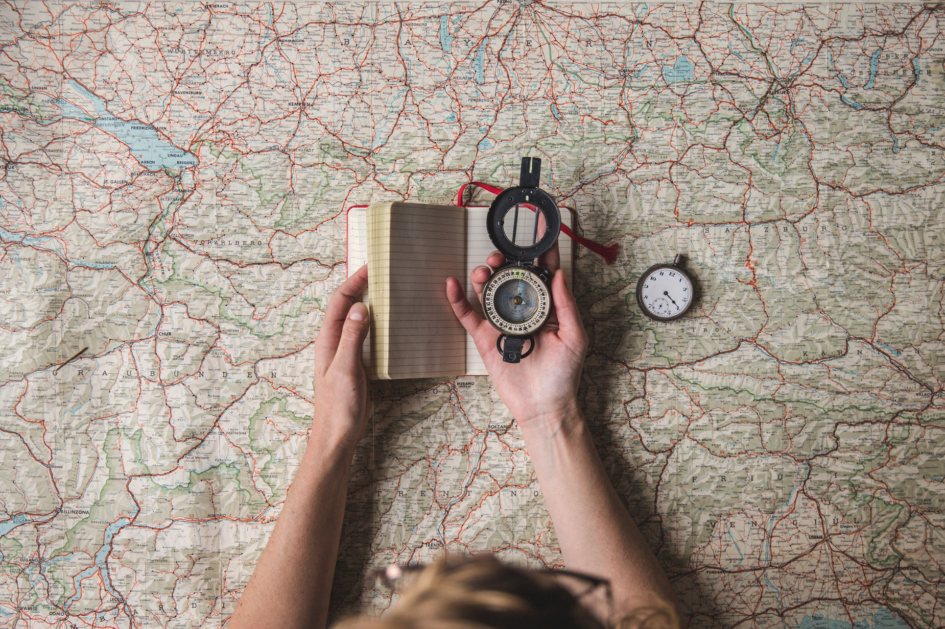 a man looking at a book on a map