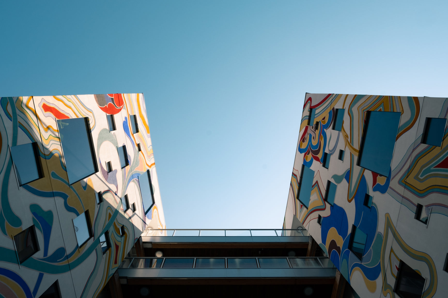 a building with different paintings on the sides and balconying