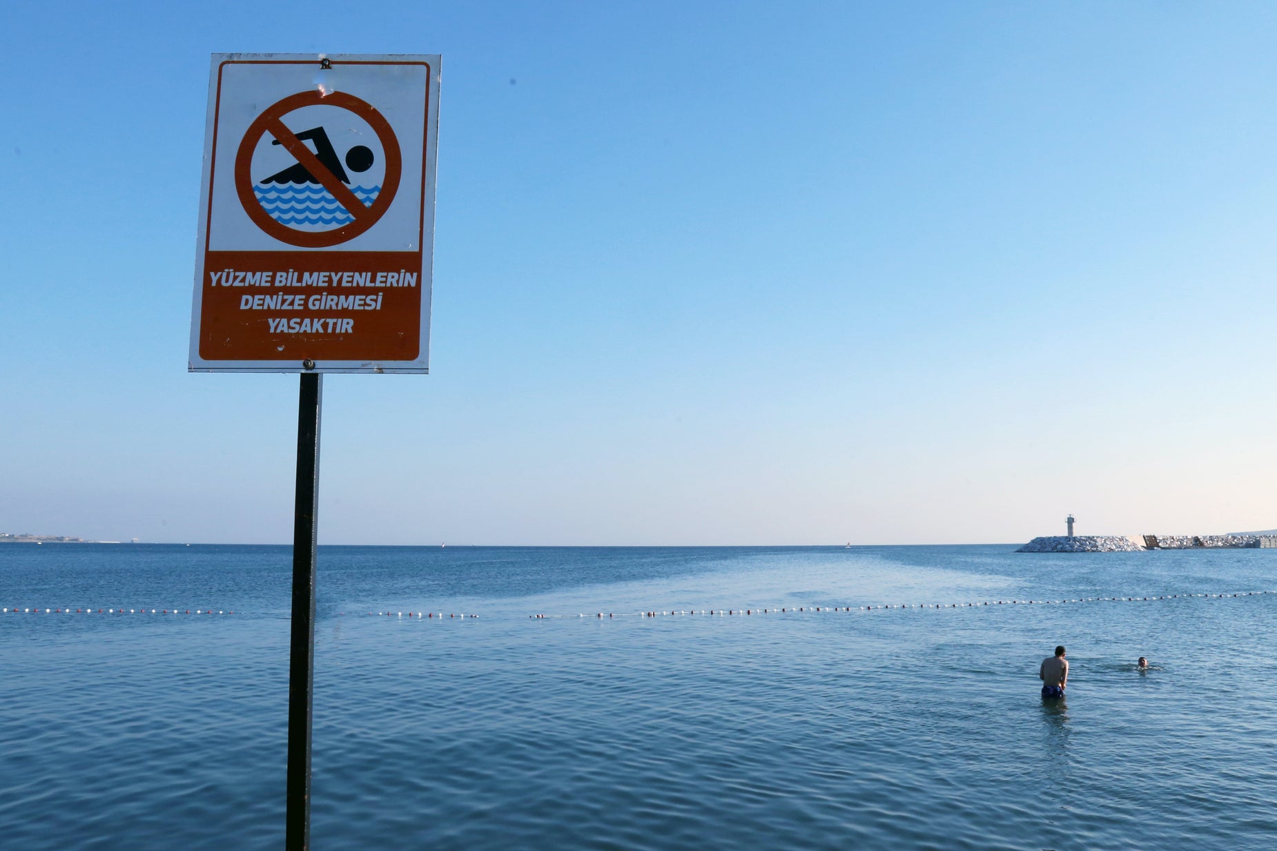 there is a sign in the ocean warning not to swim