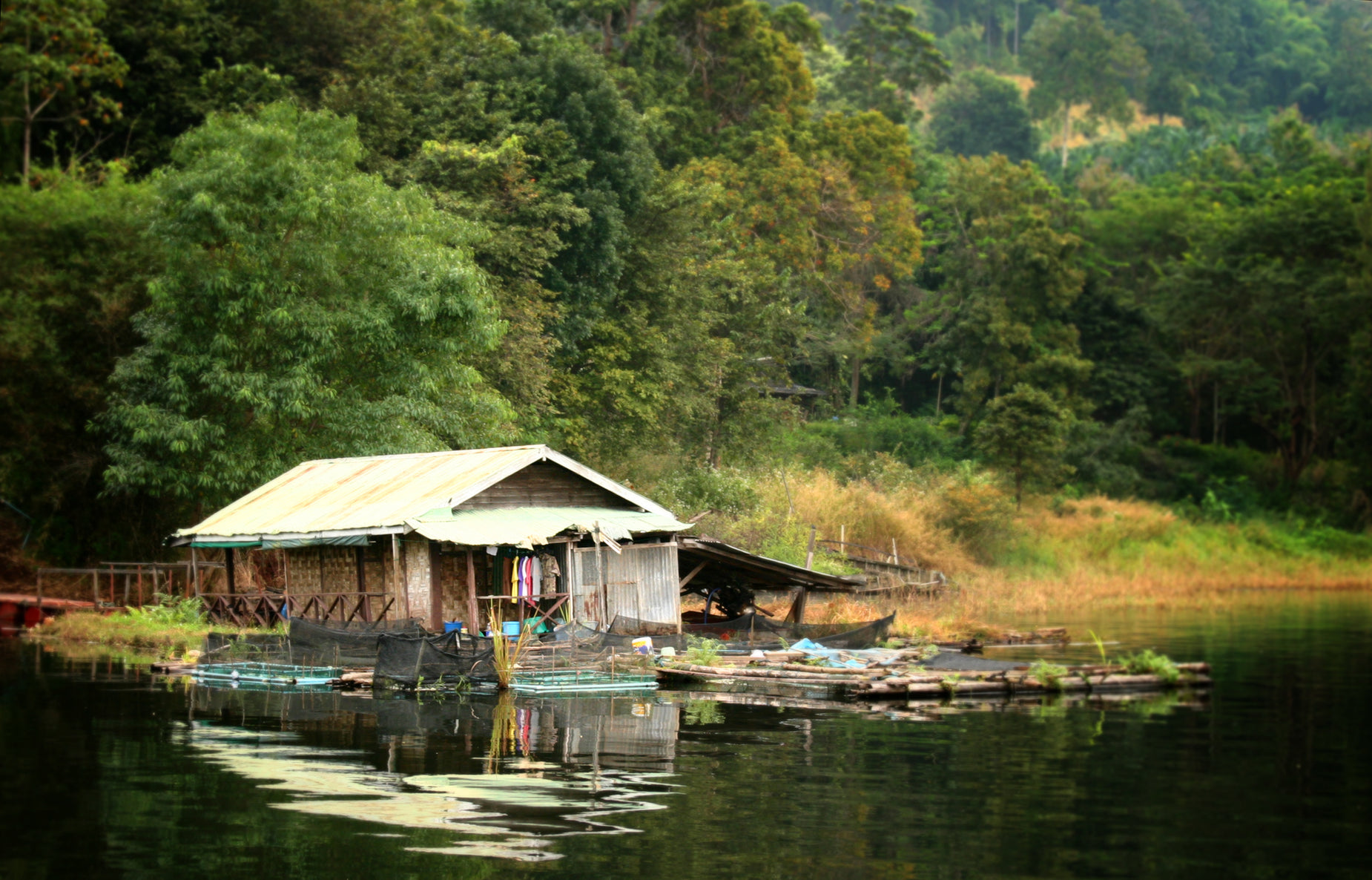 an image of a house and boats in the water