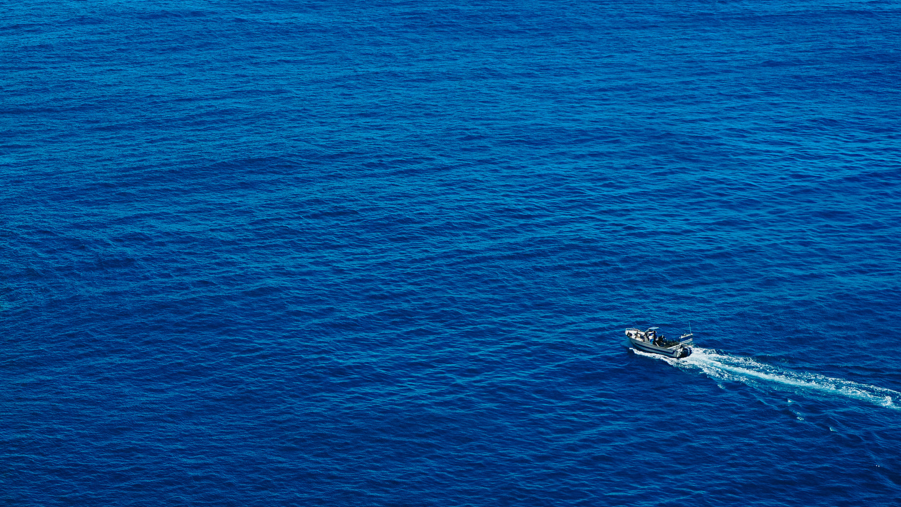 an aerial view of two boats in the water