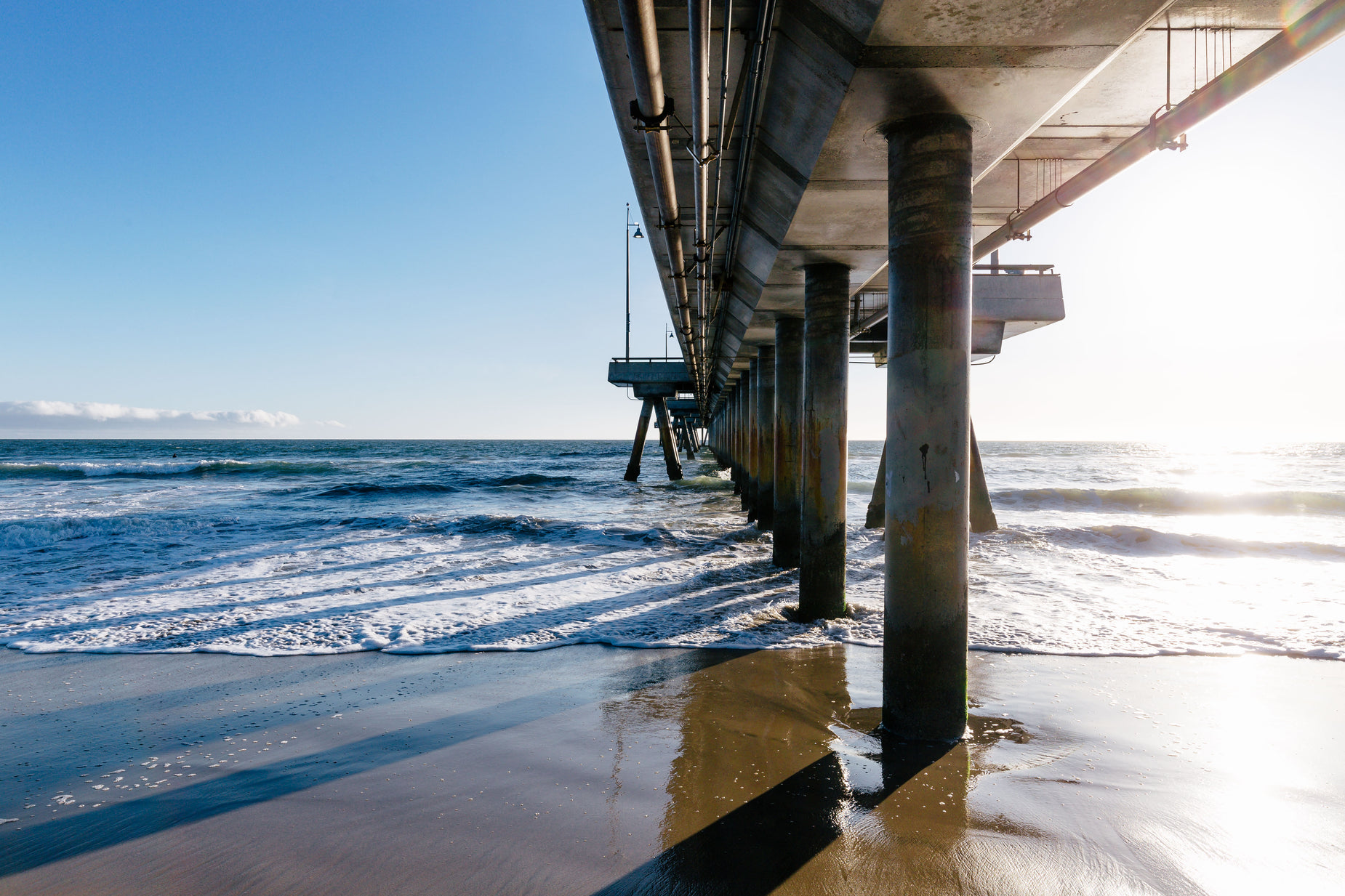 a pier over looking the ocean on a sunny day