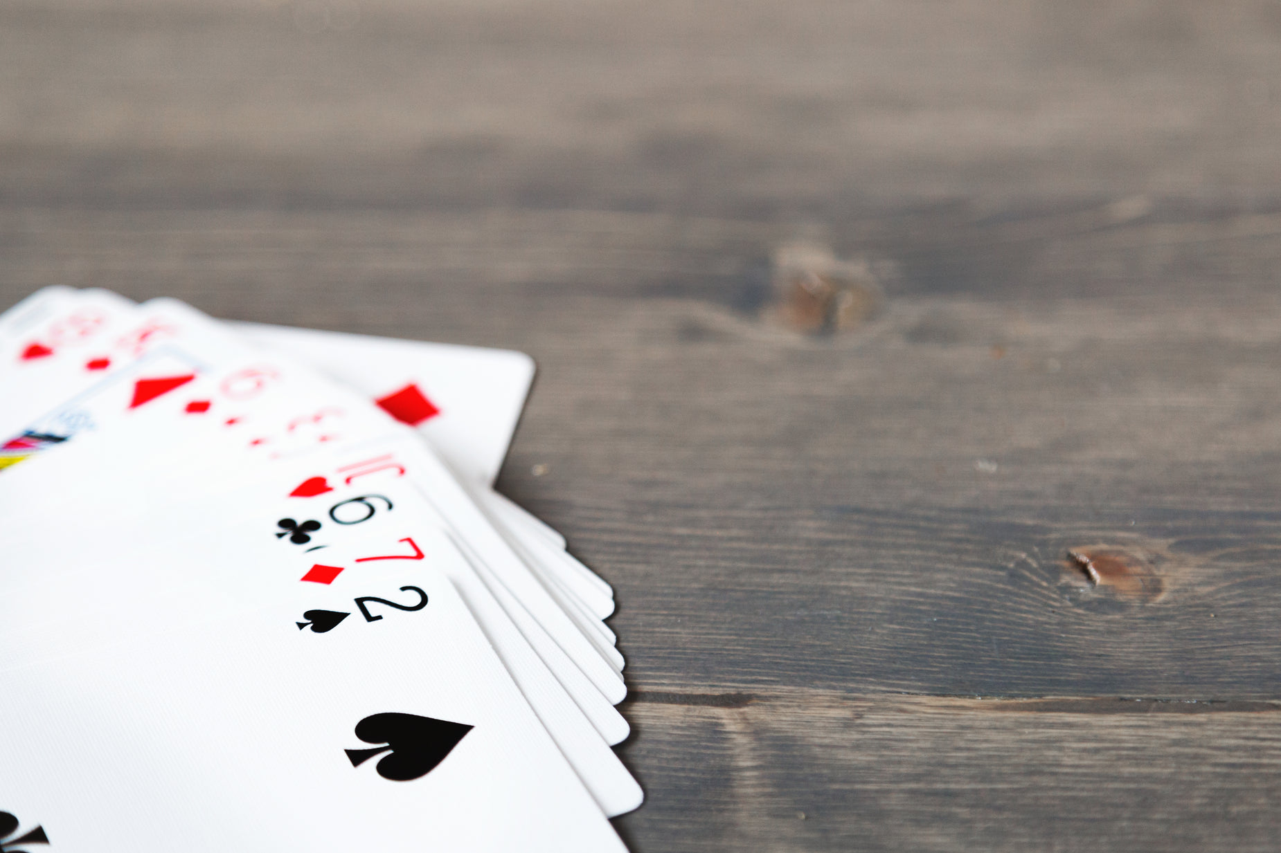 five different playing cards sitting next to each other