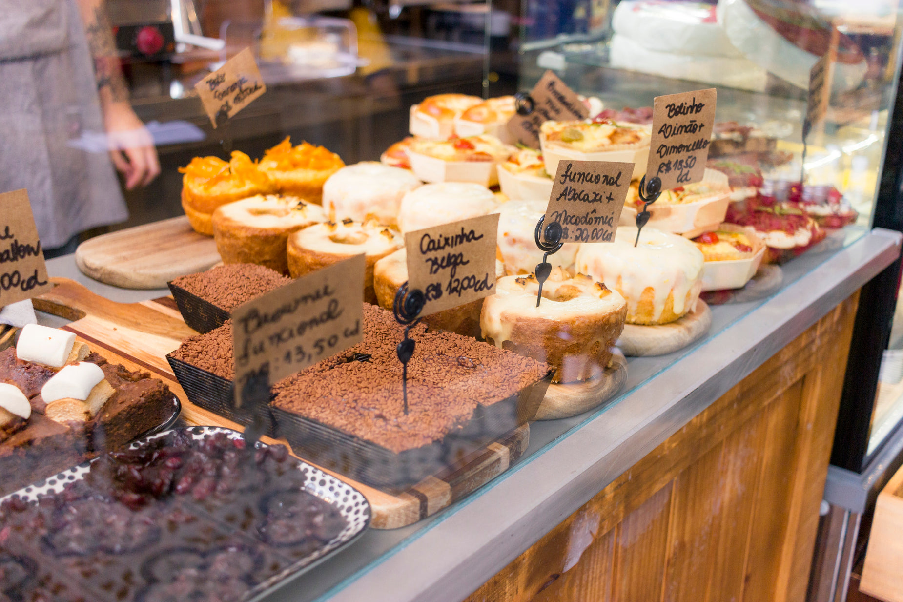 several pastries are behind a glass display in the store