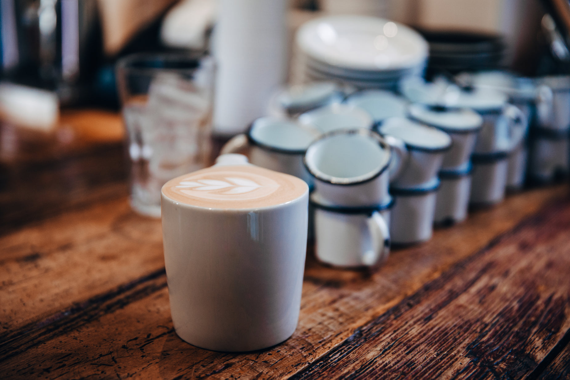 the kitchen counter is stocked with cups and bowls