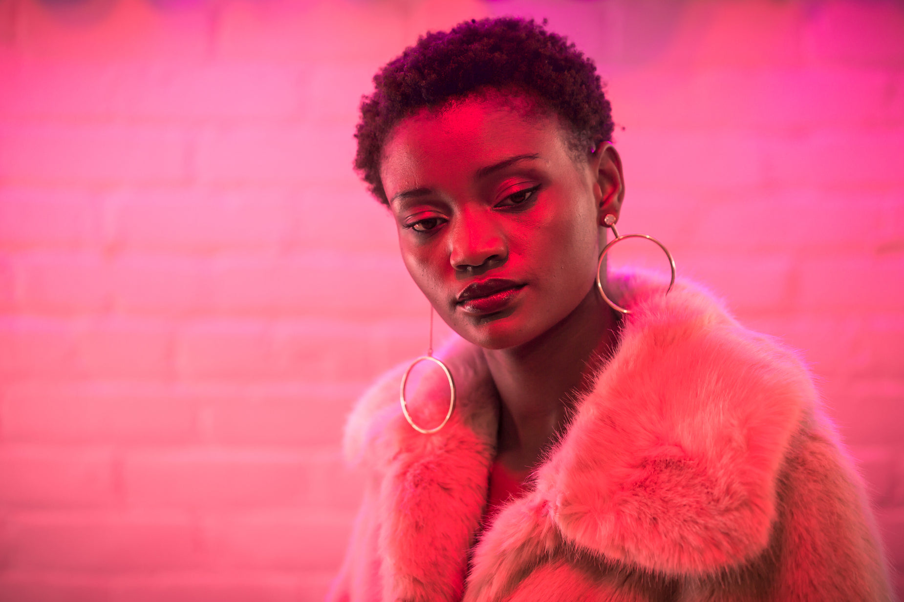 a woman with glowing makeup wearing large hoop earrings