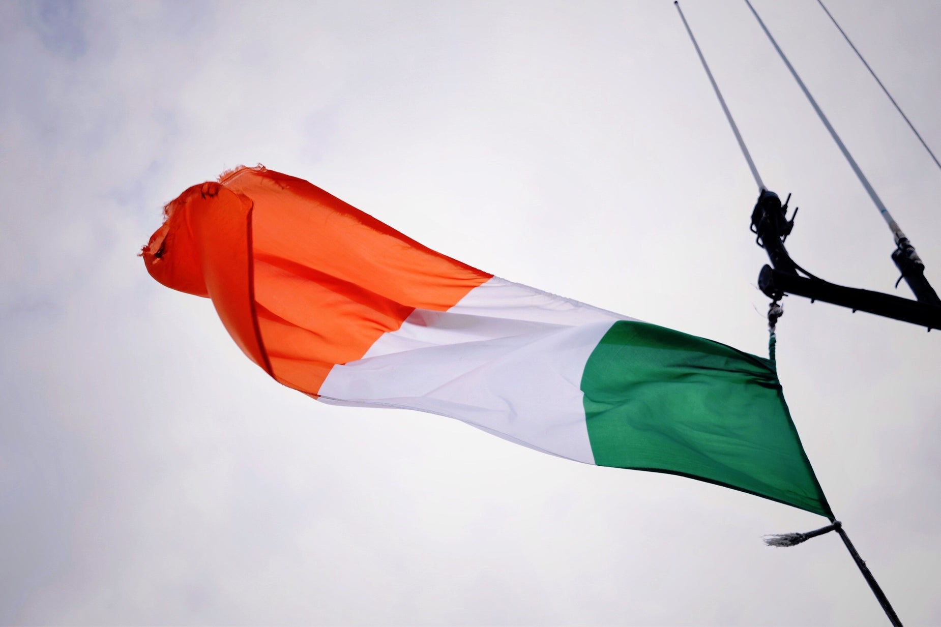 a flag flying in the sky and some poles