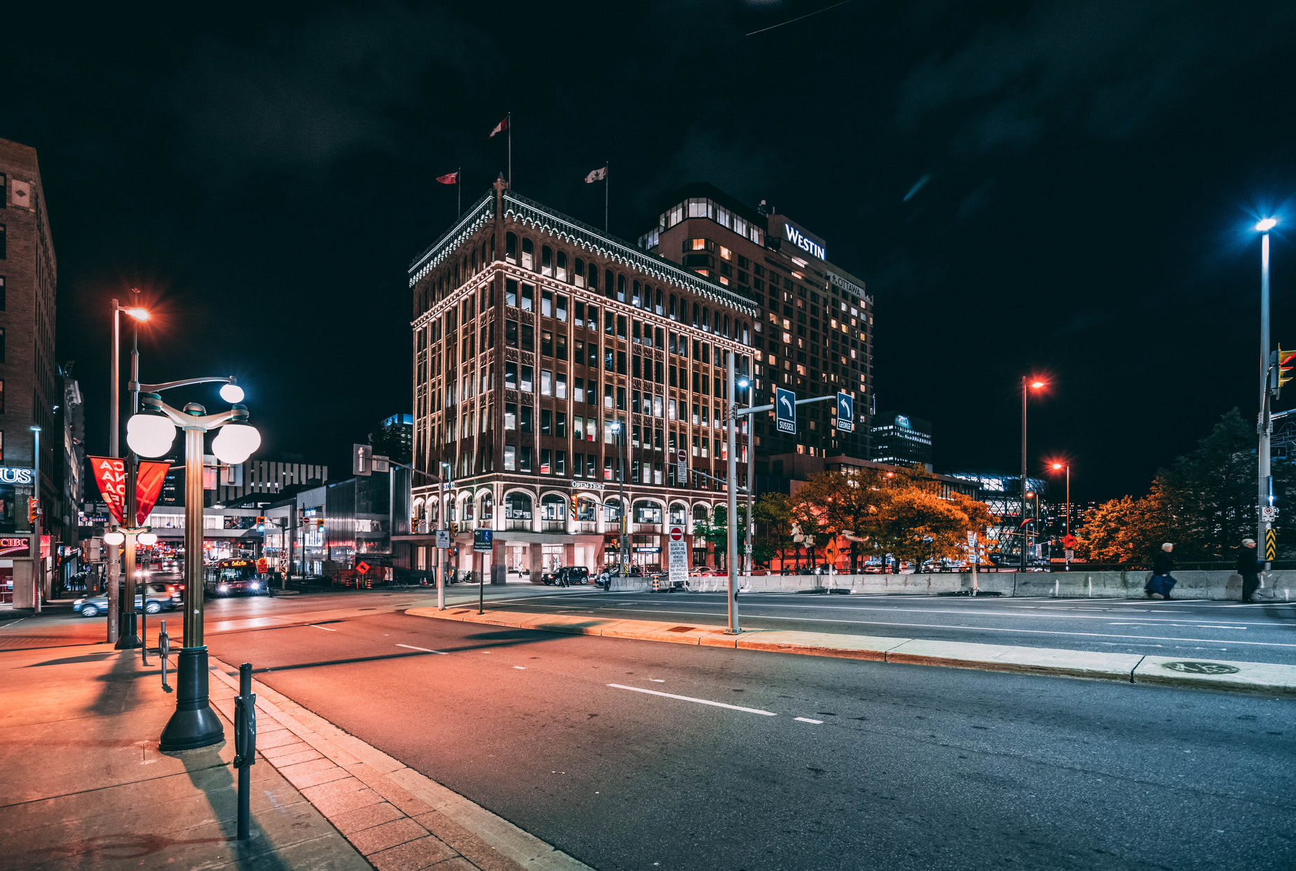 an empty city street with several traffic lights on