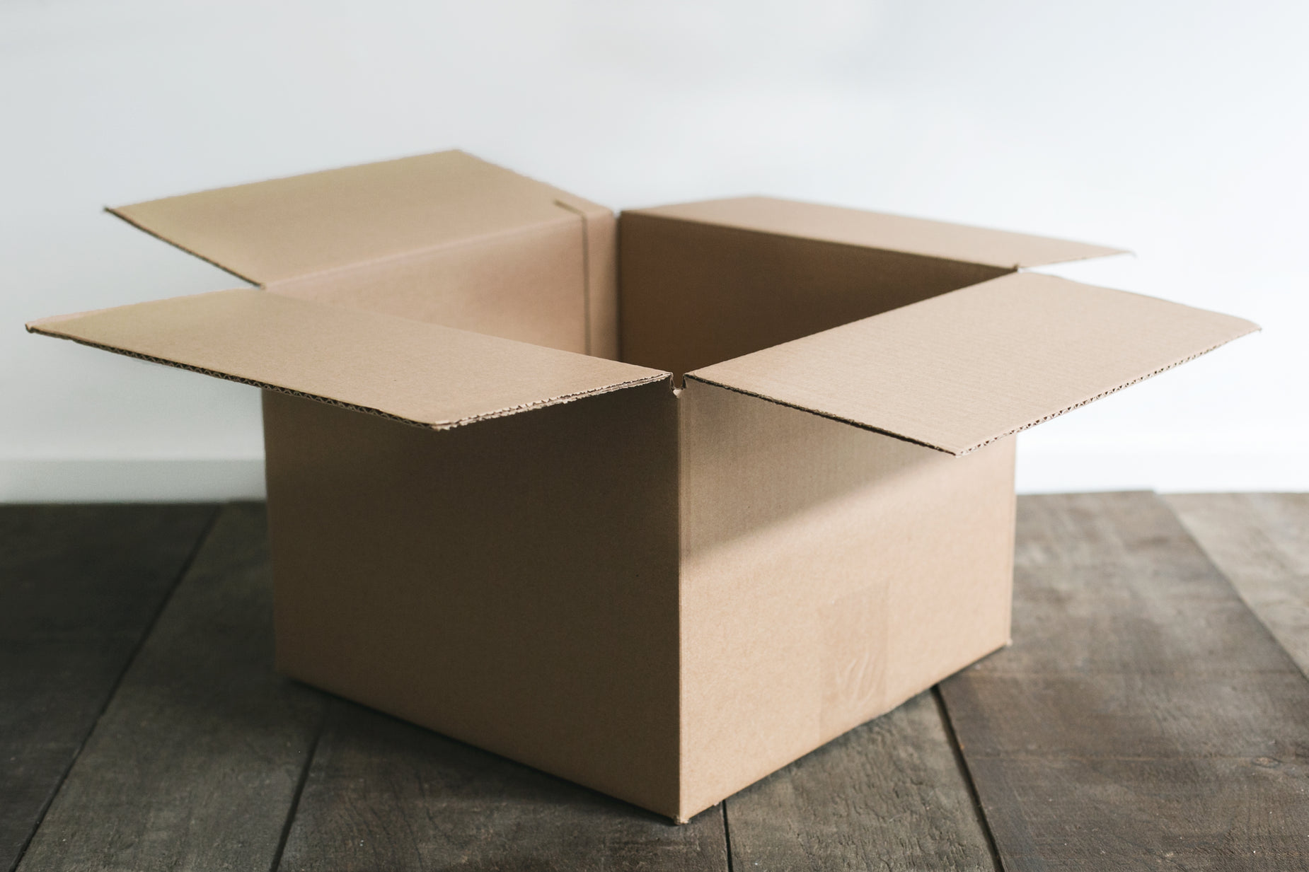 a brown open box on a wood floor