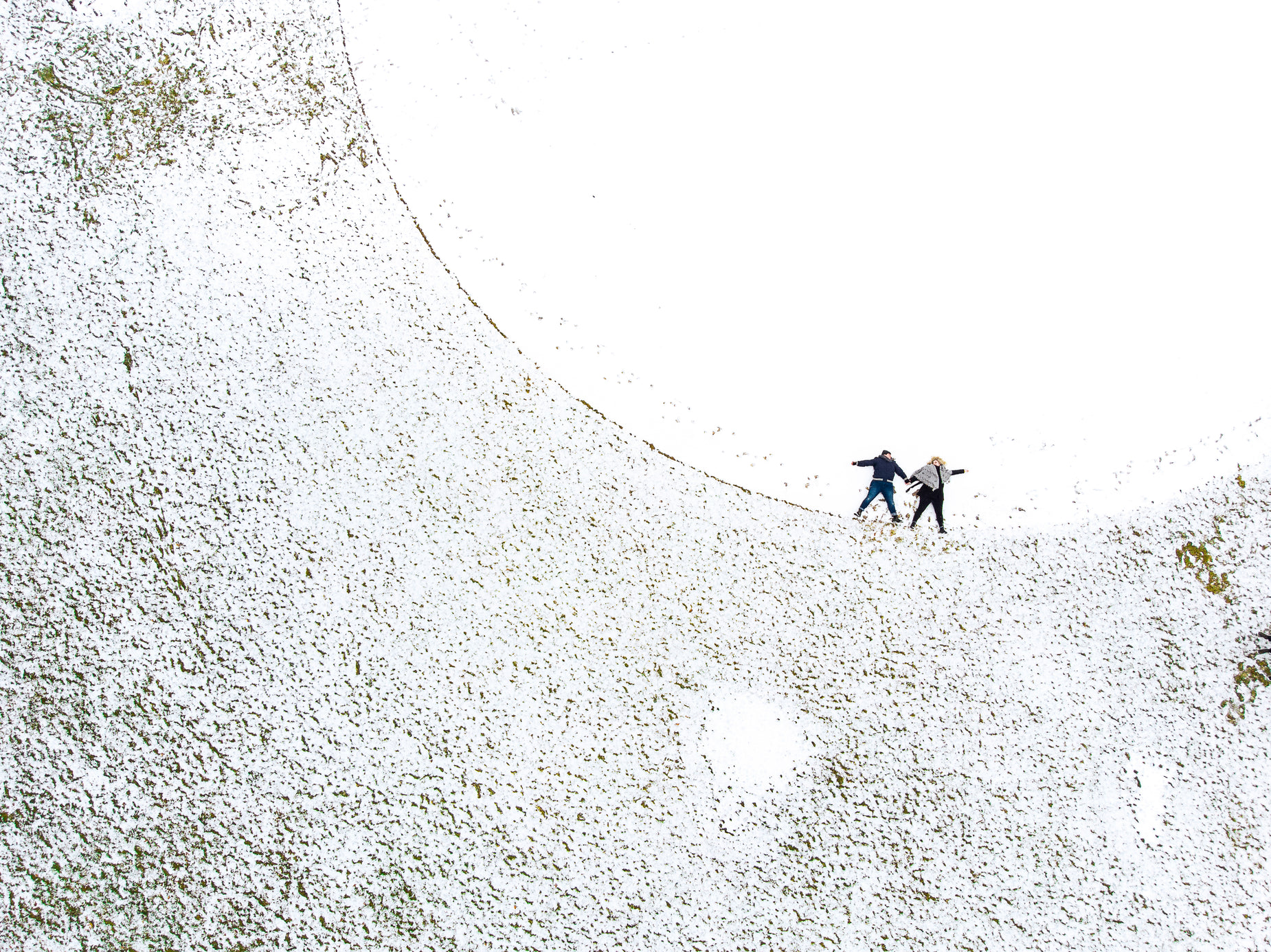 two people holding onto the string attached to a kite