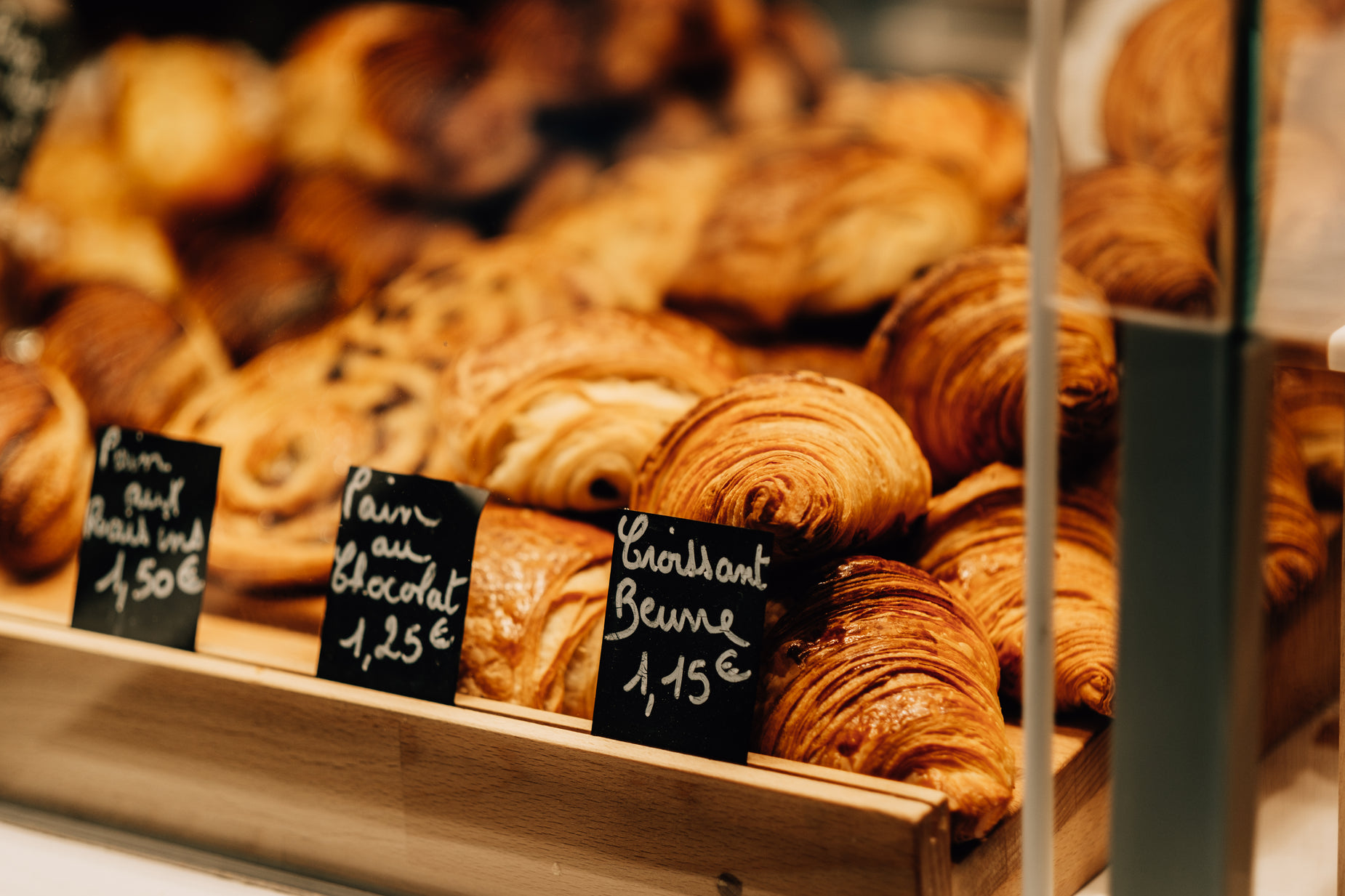 there are different types of bread and pastries on display