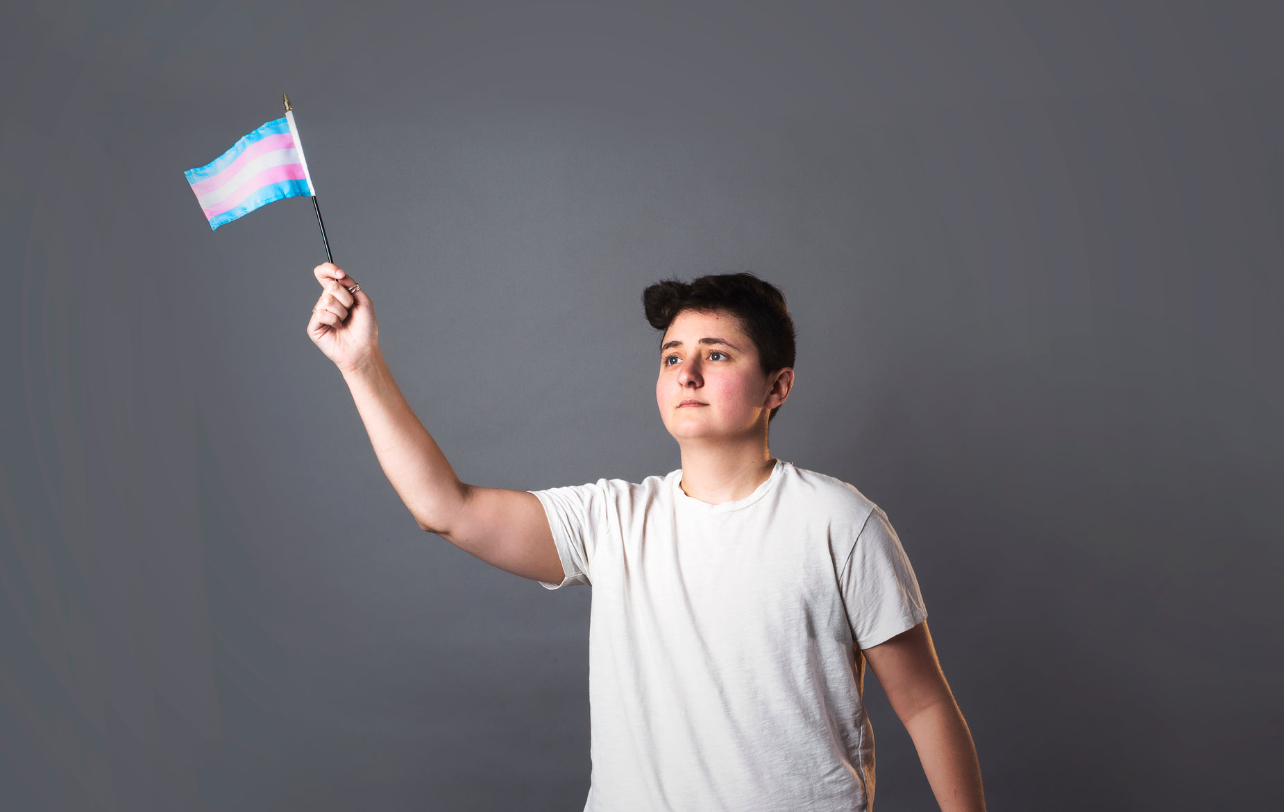 young man holding flag and posing for the camera