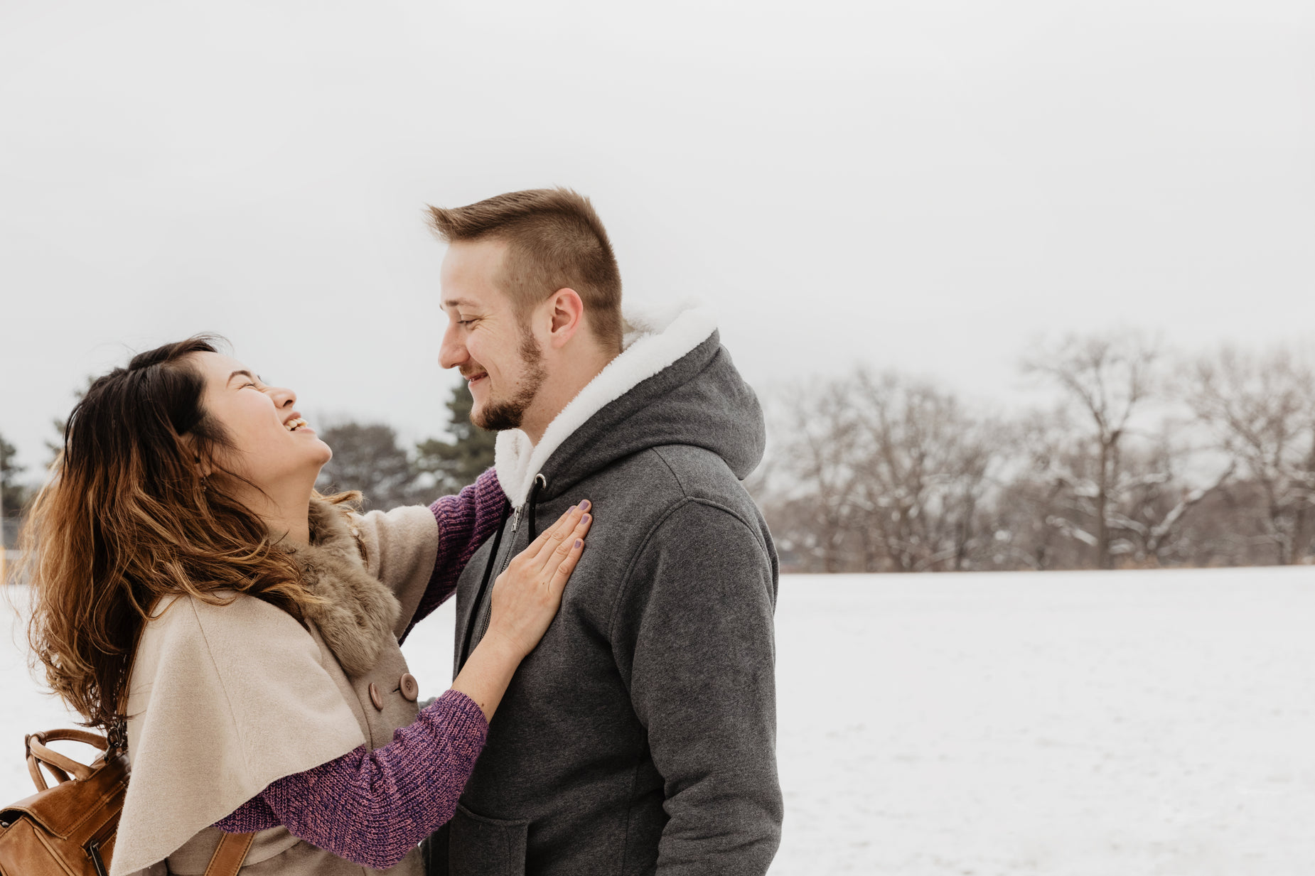 a couple standing together in the snow