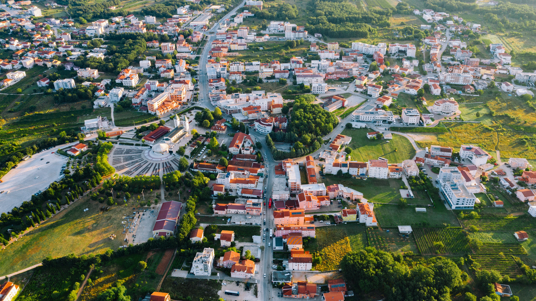 an aerial view of a small town with mountains in the distance