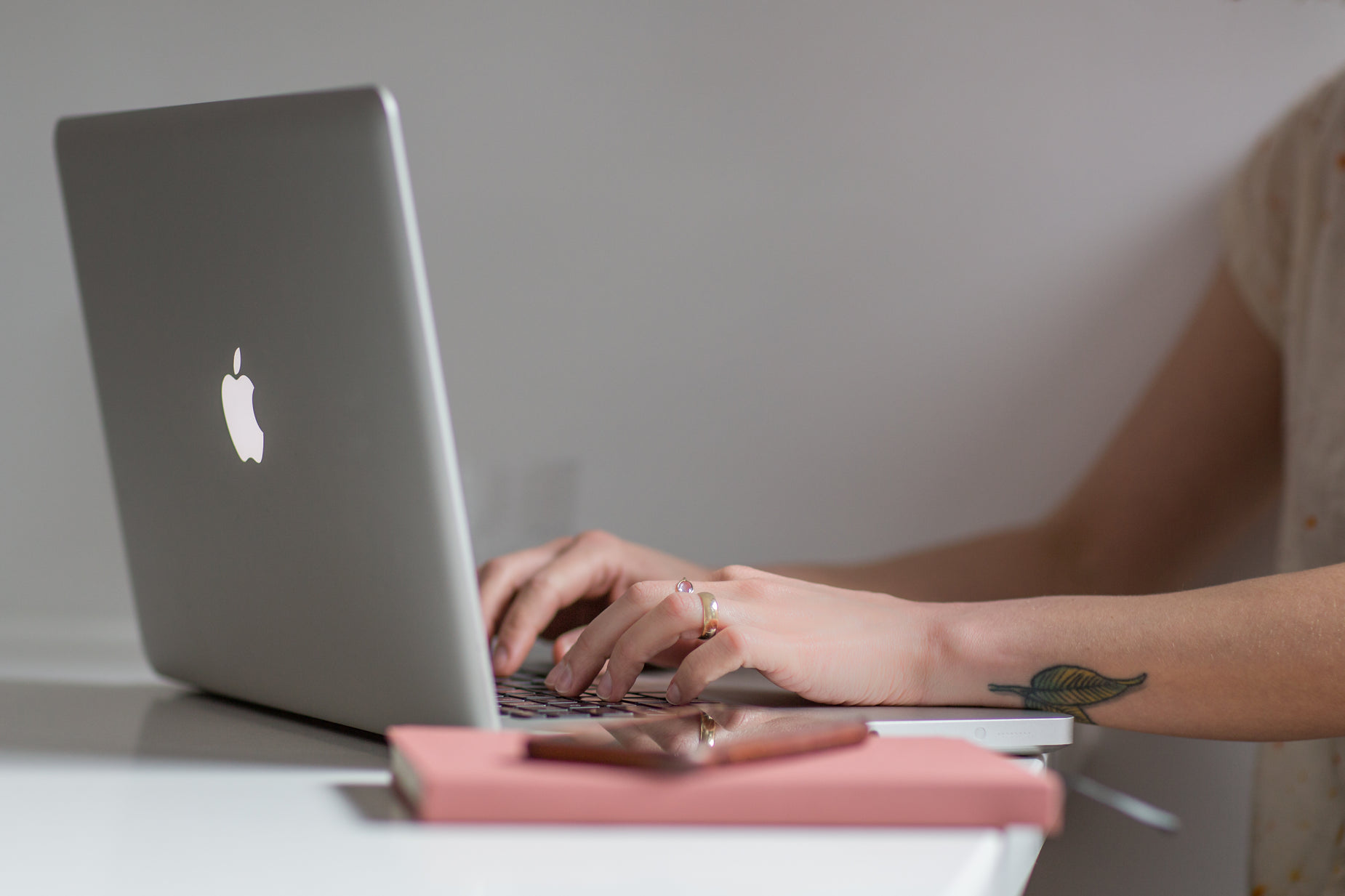 a woman sitting at a desk using a laptop computer