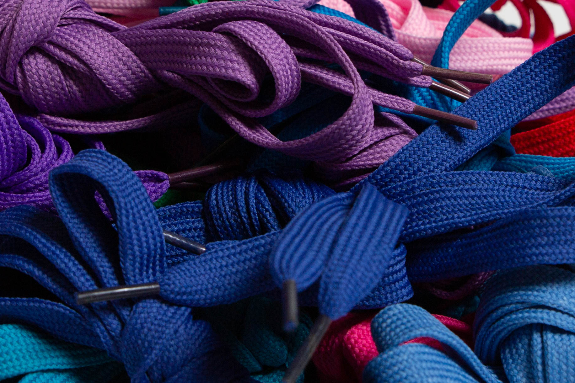a pile of different color ropes next to each other