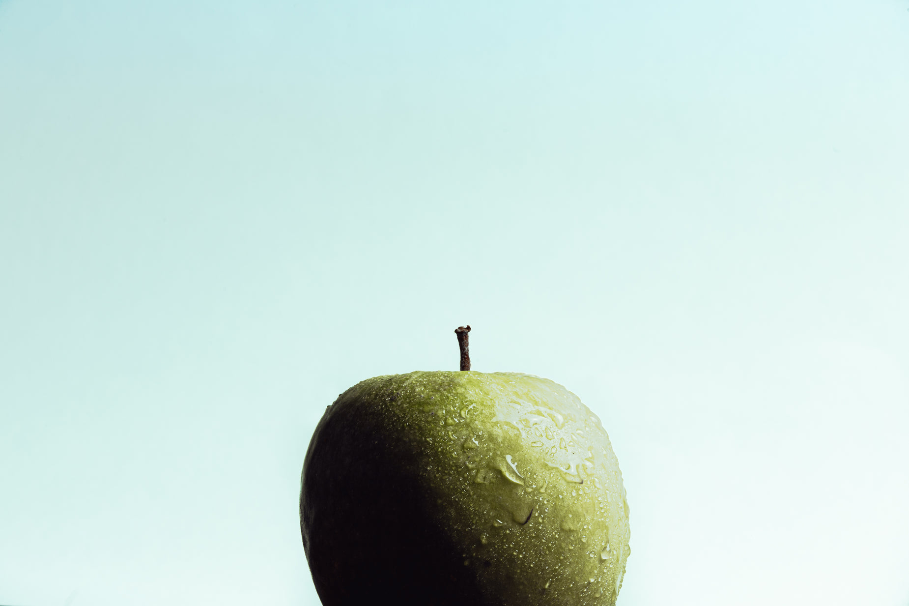 a close up of an apple with a sky background