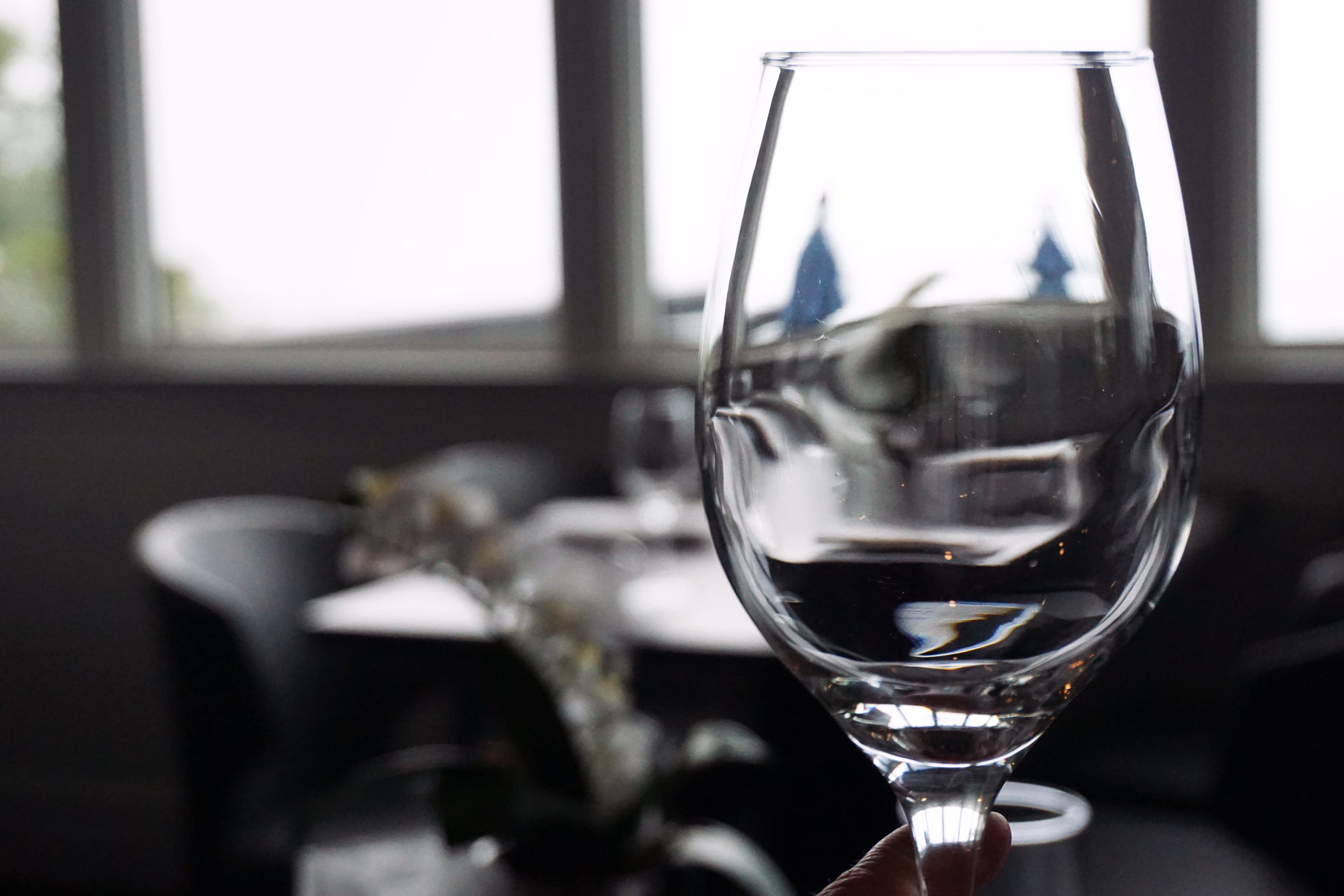 a wine glass is being filled with a liquid