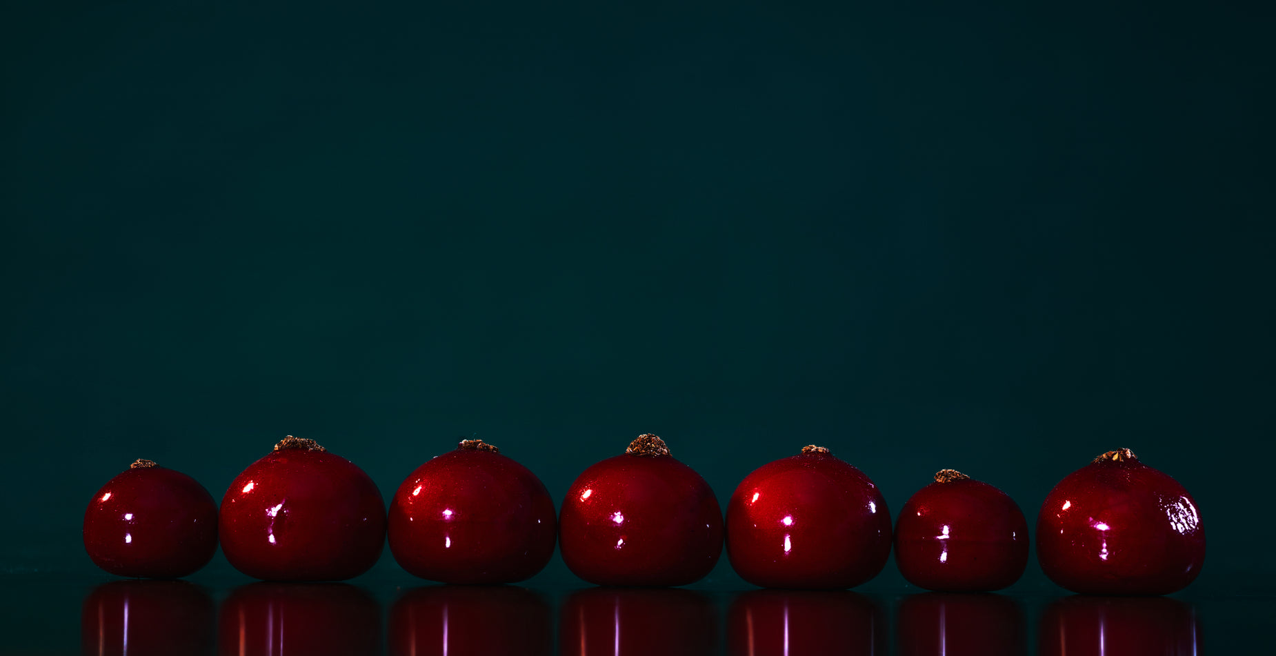 a group of red apples lined up in a row